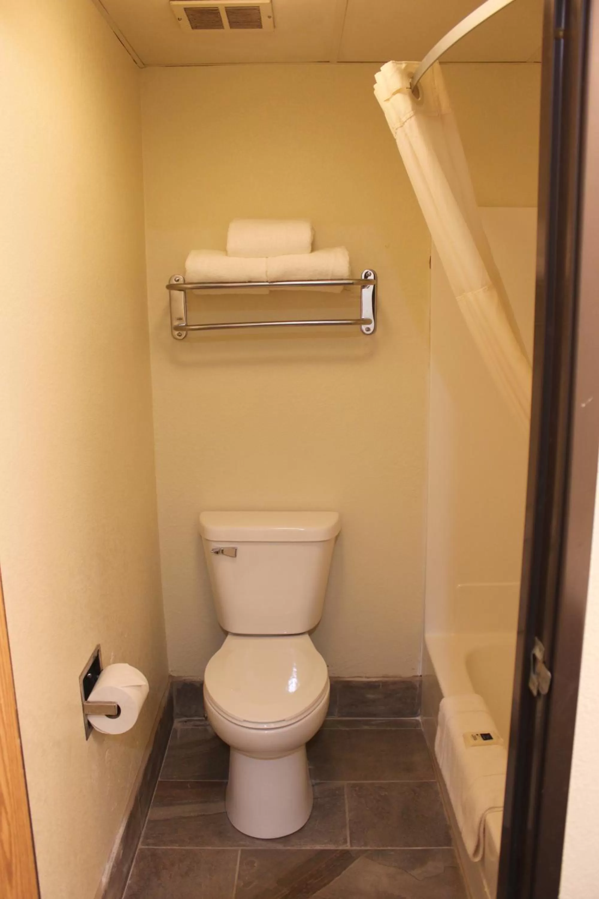 Toilet in AmericInn by Wyndham West Burlington