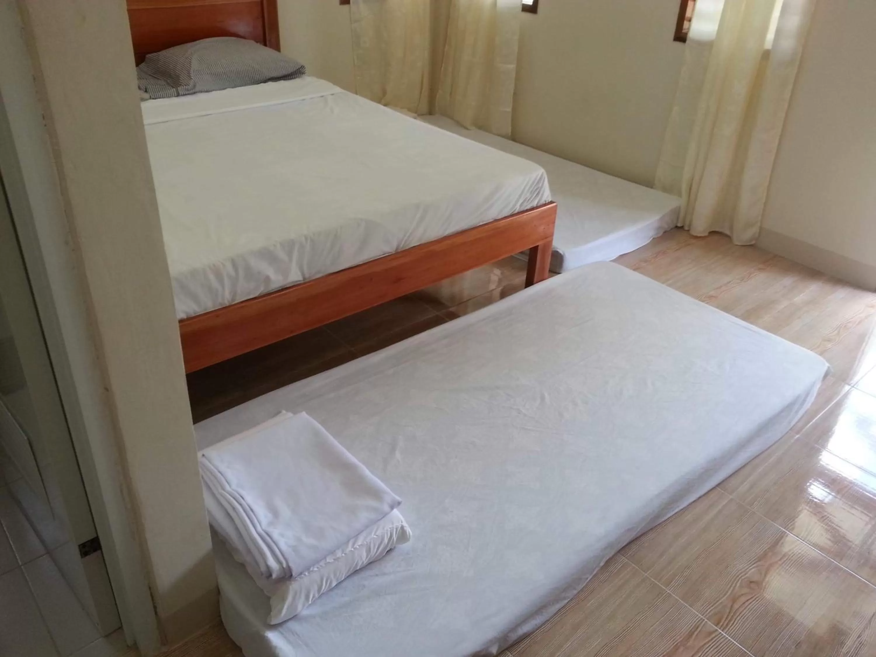 Bed in D's Oceanview Beach Resort