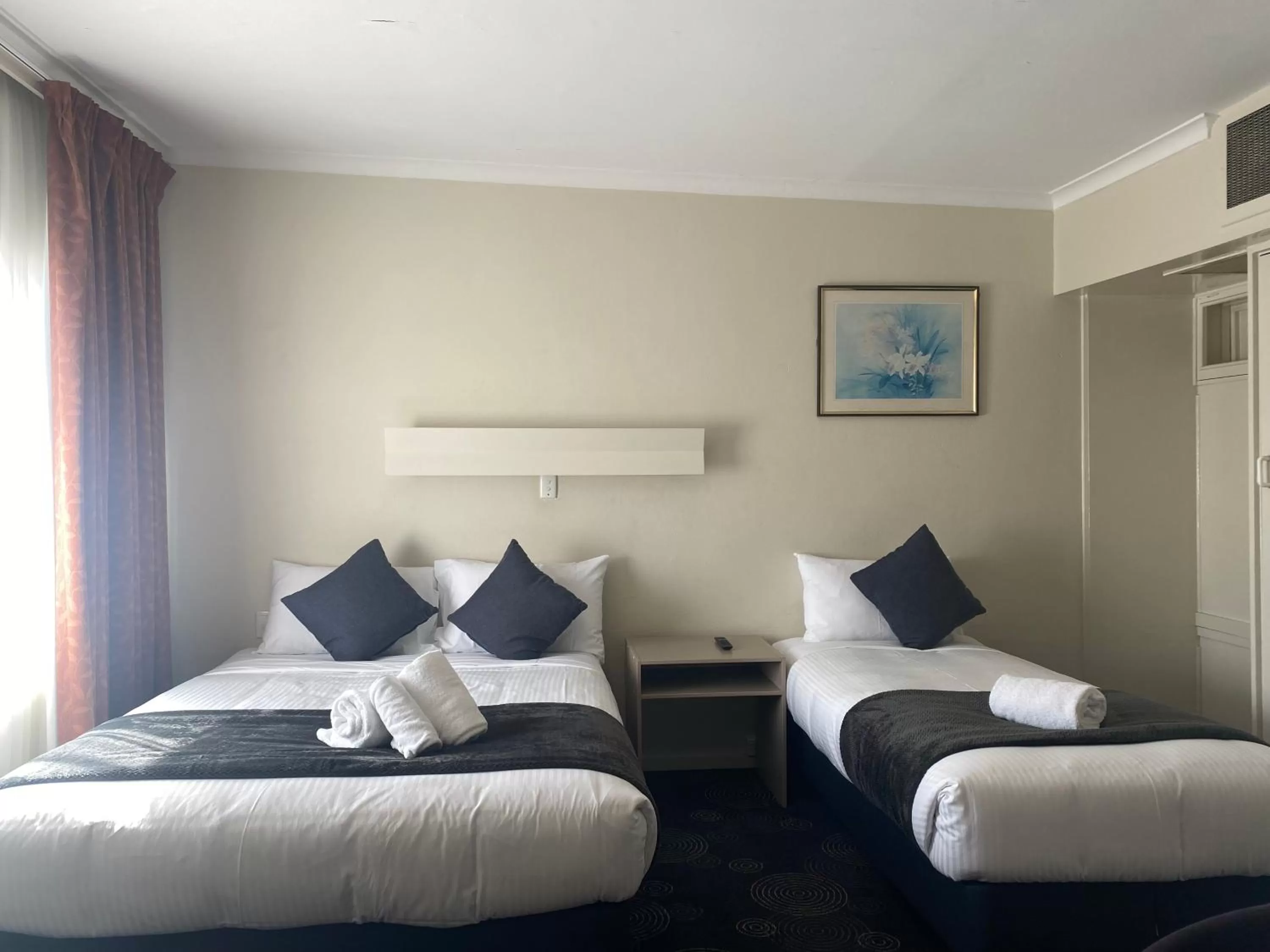 Bed in The Astor Hotel Motel