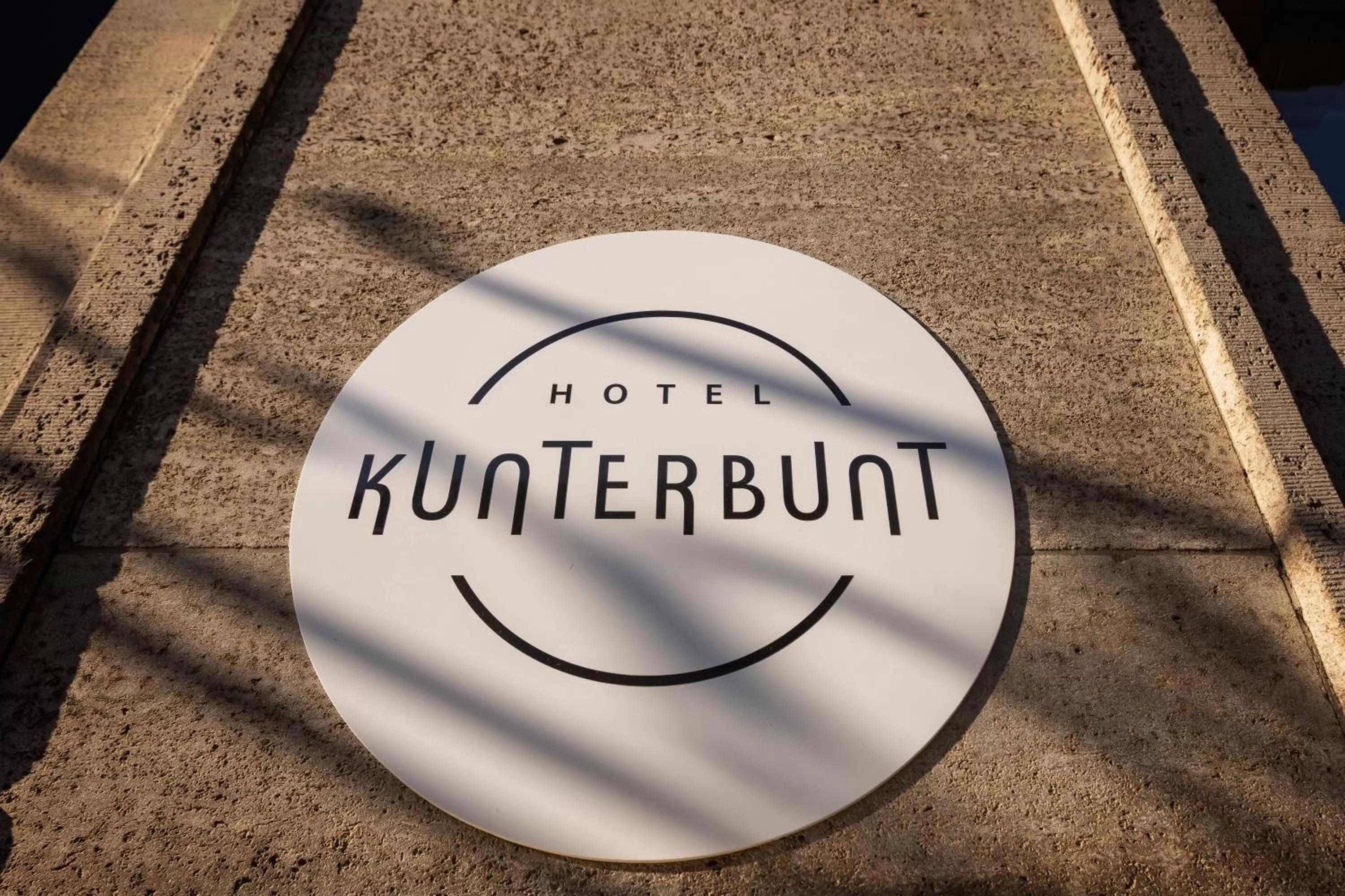 Property logo or sign in Hotel Kunterbunt - by homekeepers