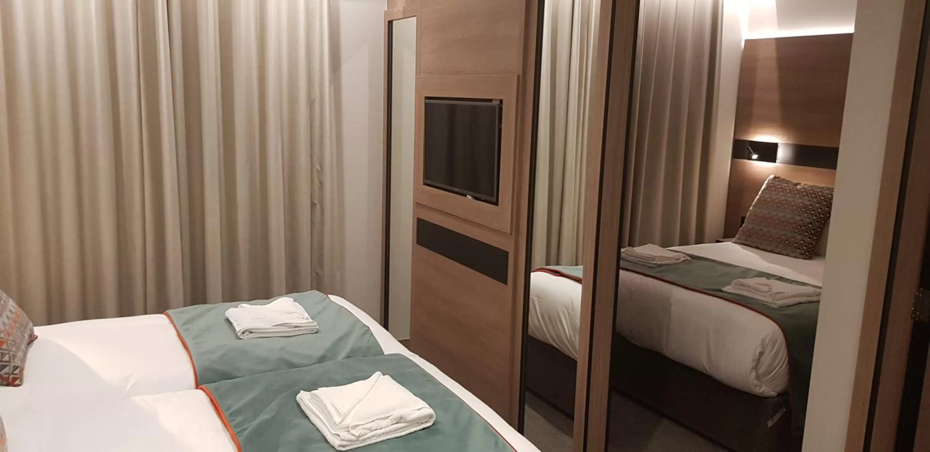 Bed in Merit Kensington Hotel