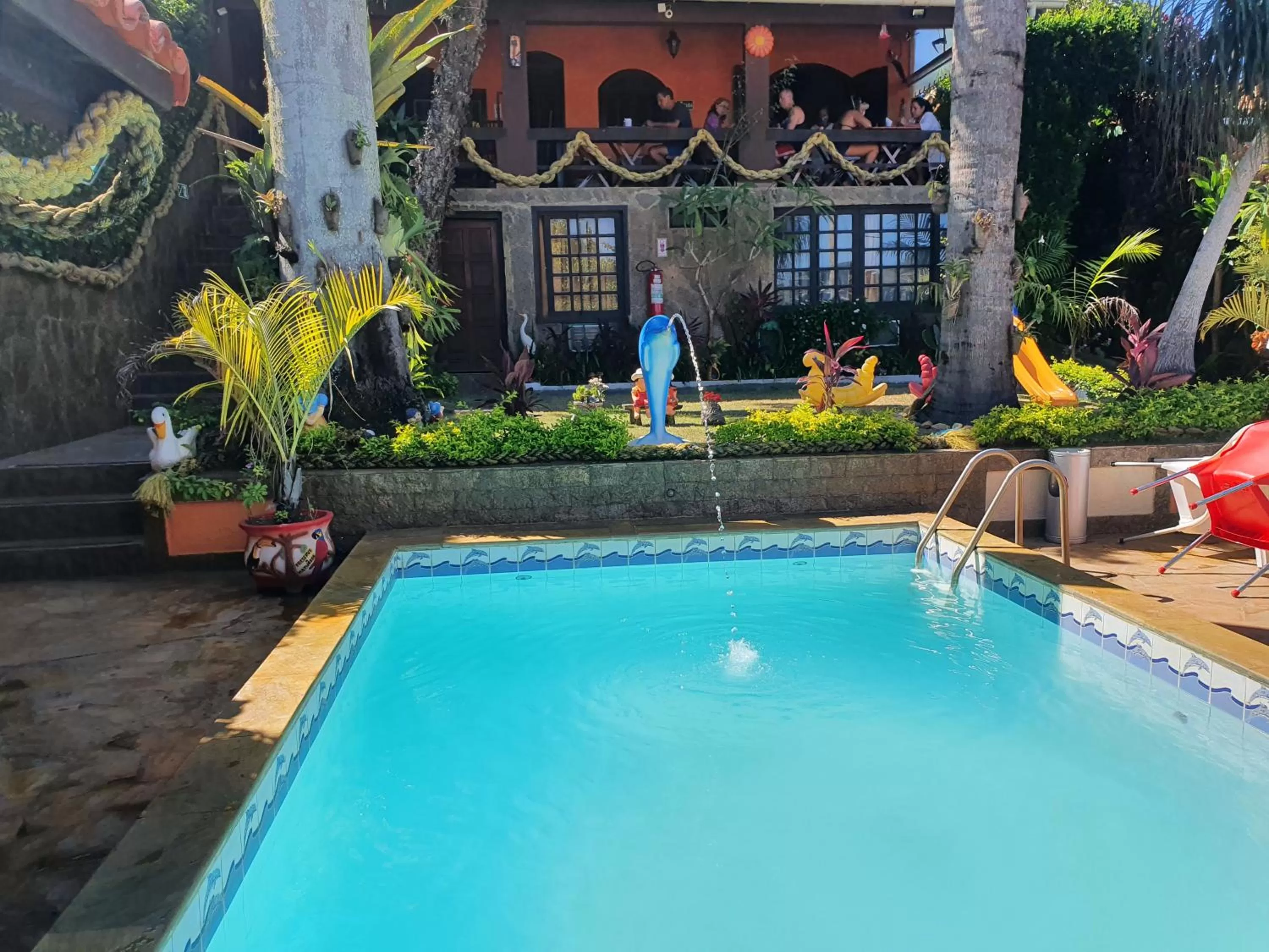 Swimming pool in Suítes Casa do Barão