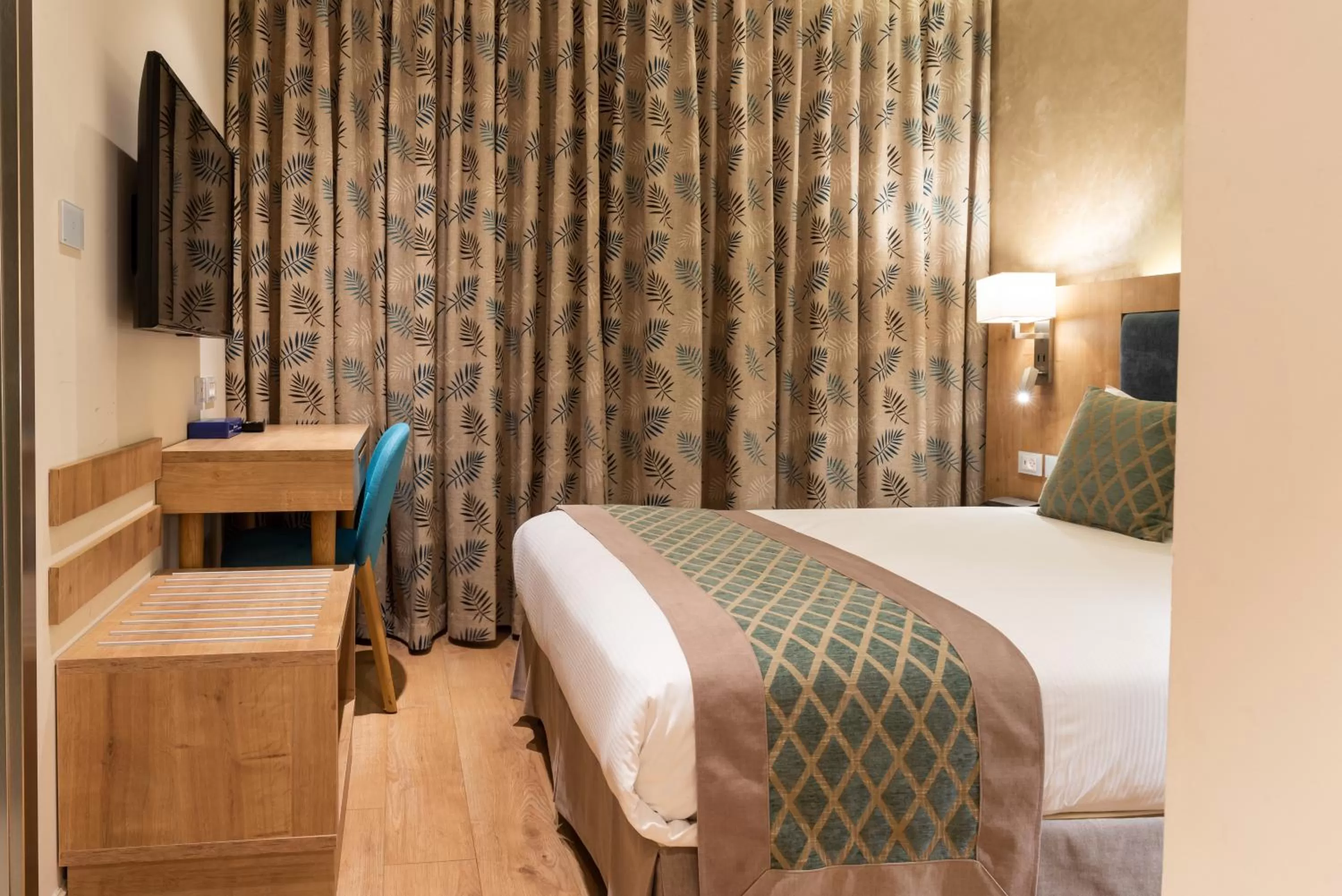 Bed in Ambassador Boutique Hotel