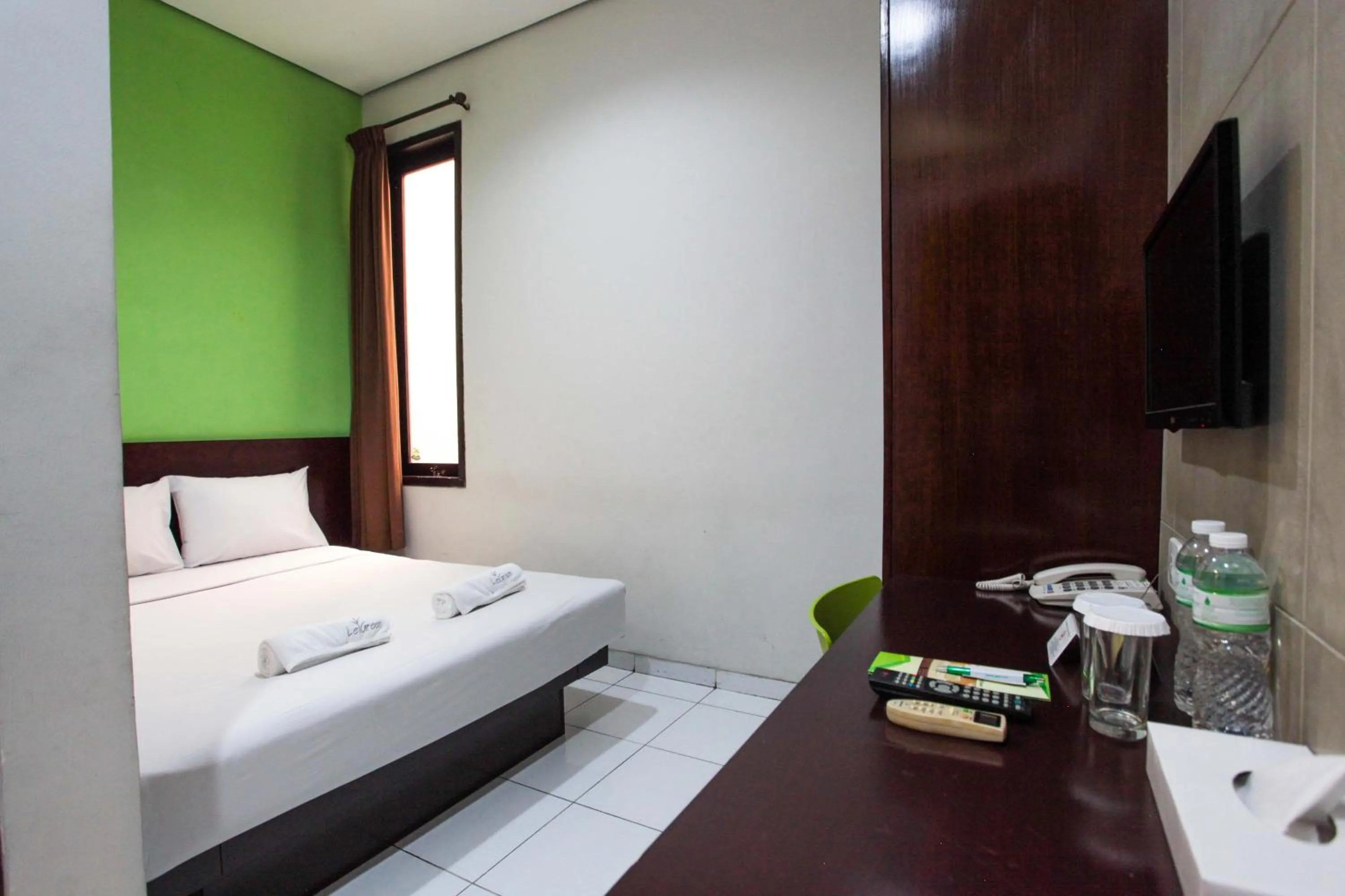 Bed in LeGreen Suite Setiabudi