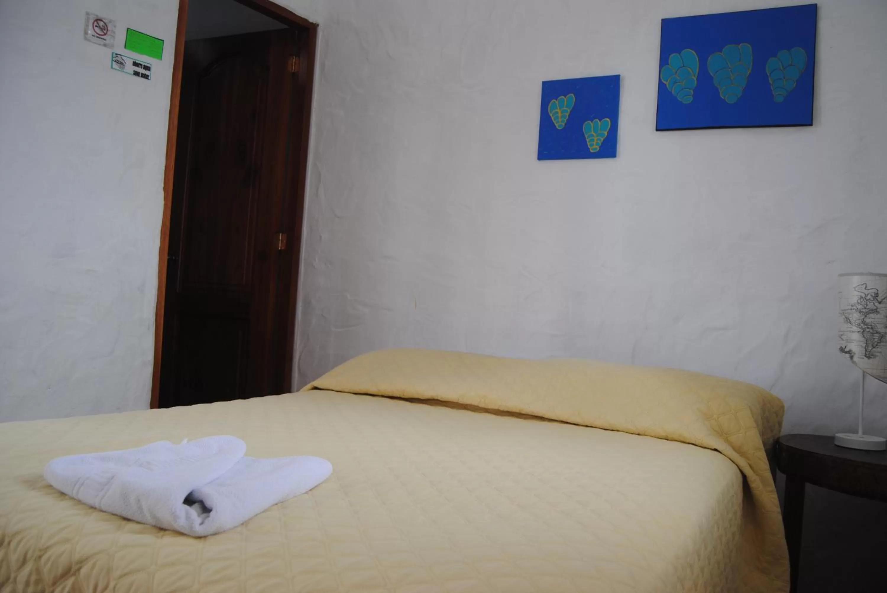 Bed in Hostal Galapagos by Bar de Beto