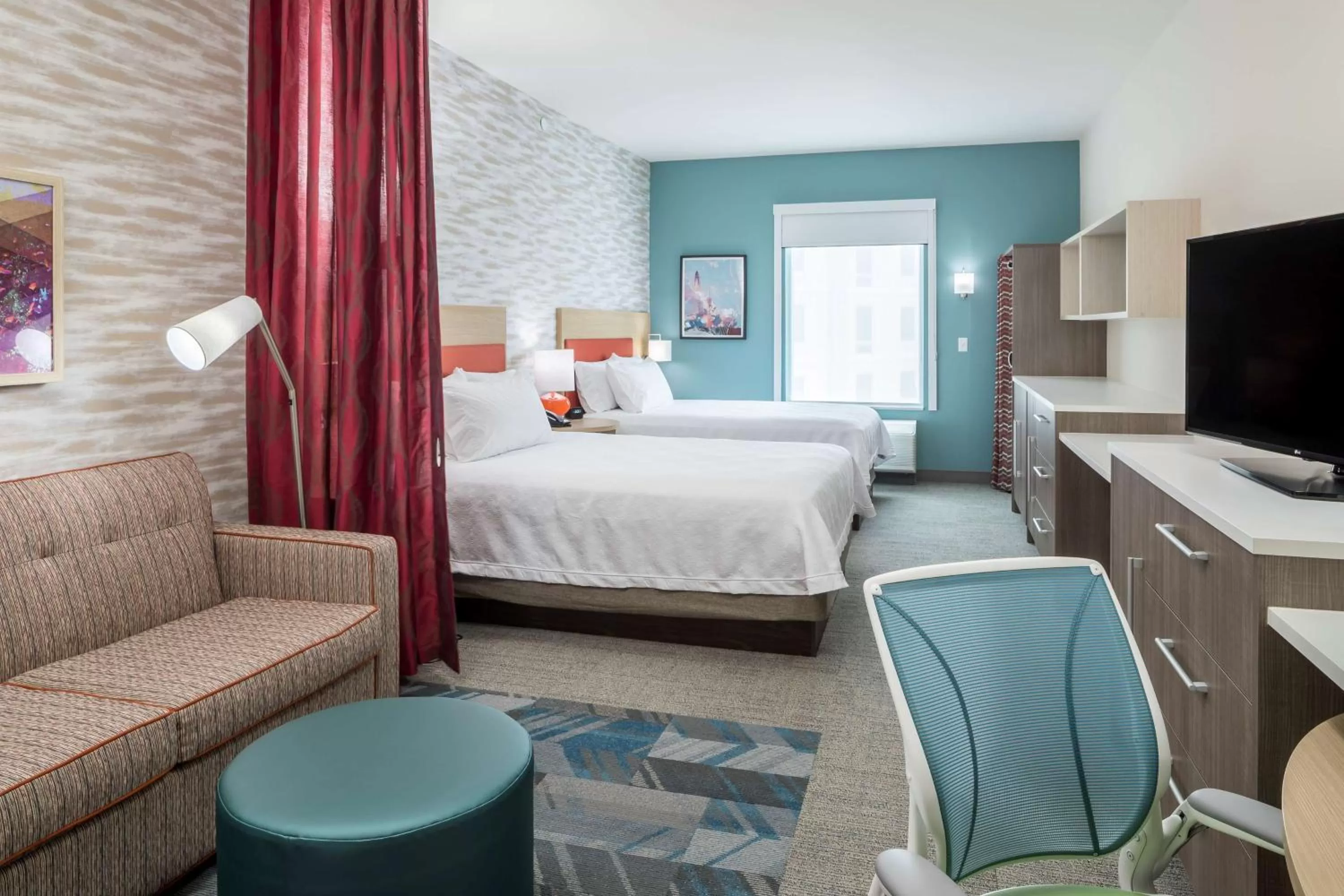 Living room, Bed in Home2 Suites By Hilton Cape Canaveral Cruise Port