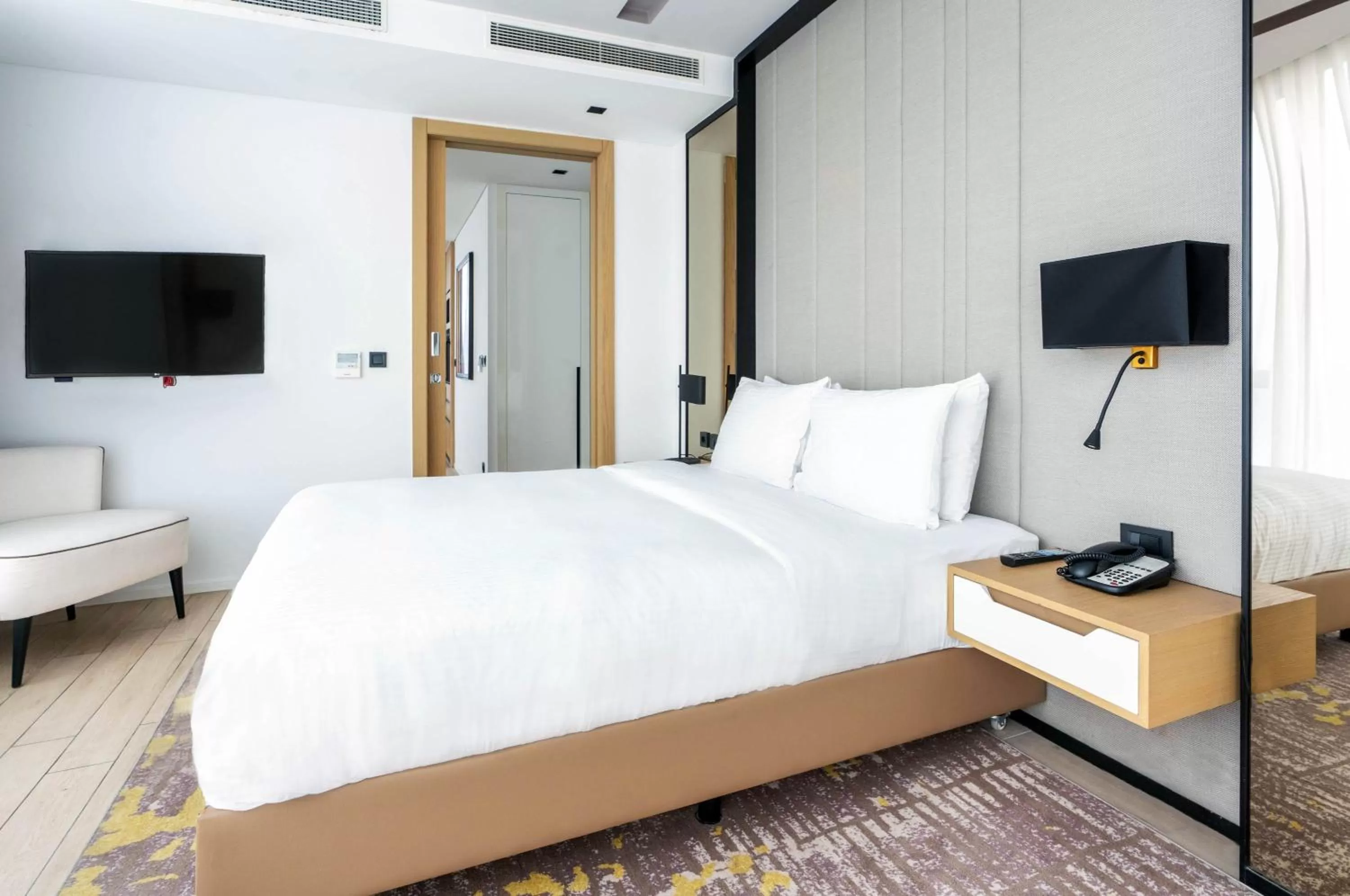 Bed in WestSide Residences by Rotana