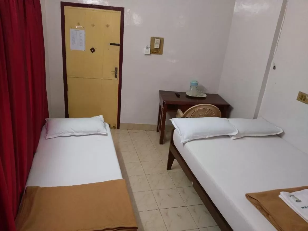 Bed in Anandan Tourist Home