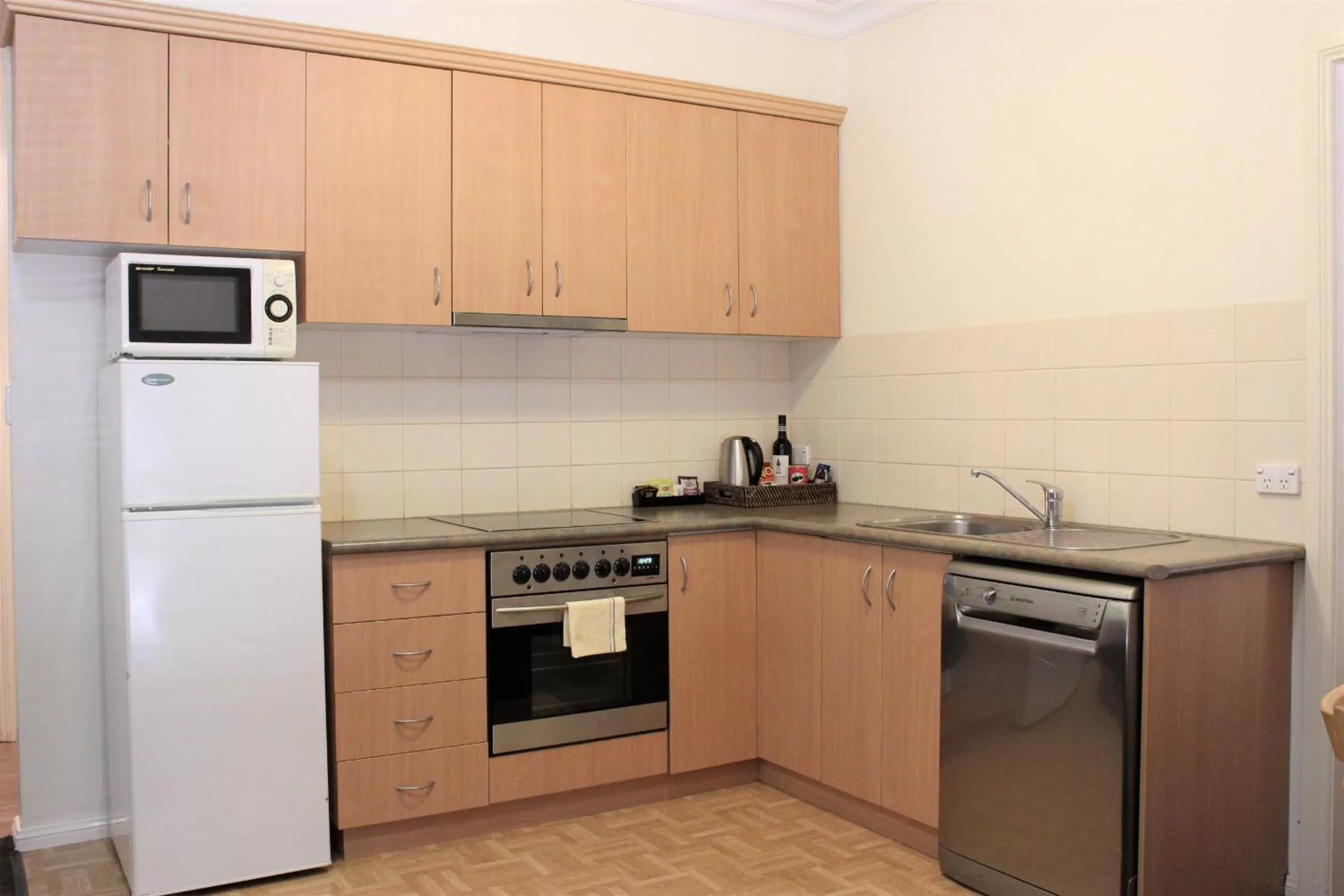 Kitchen or kitchenette in Carlyle Suites & Apartments