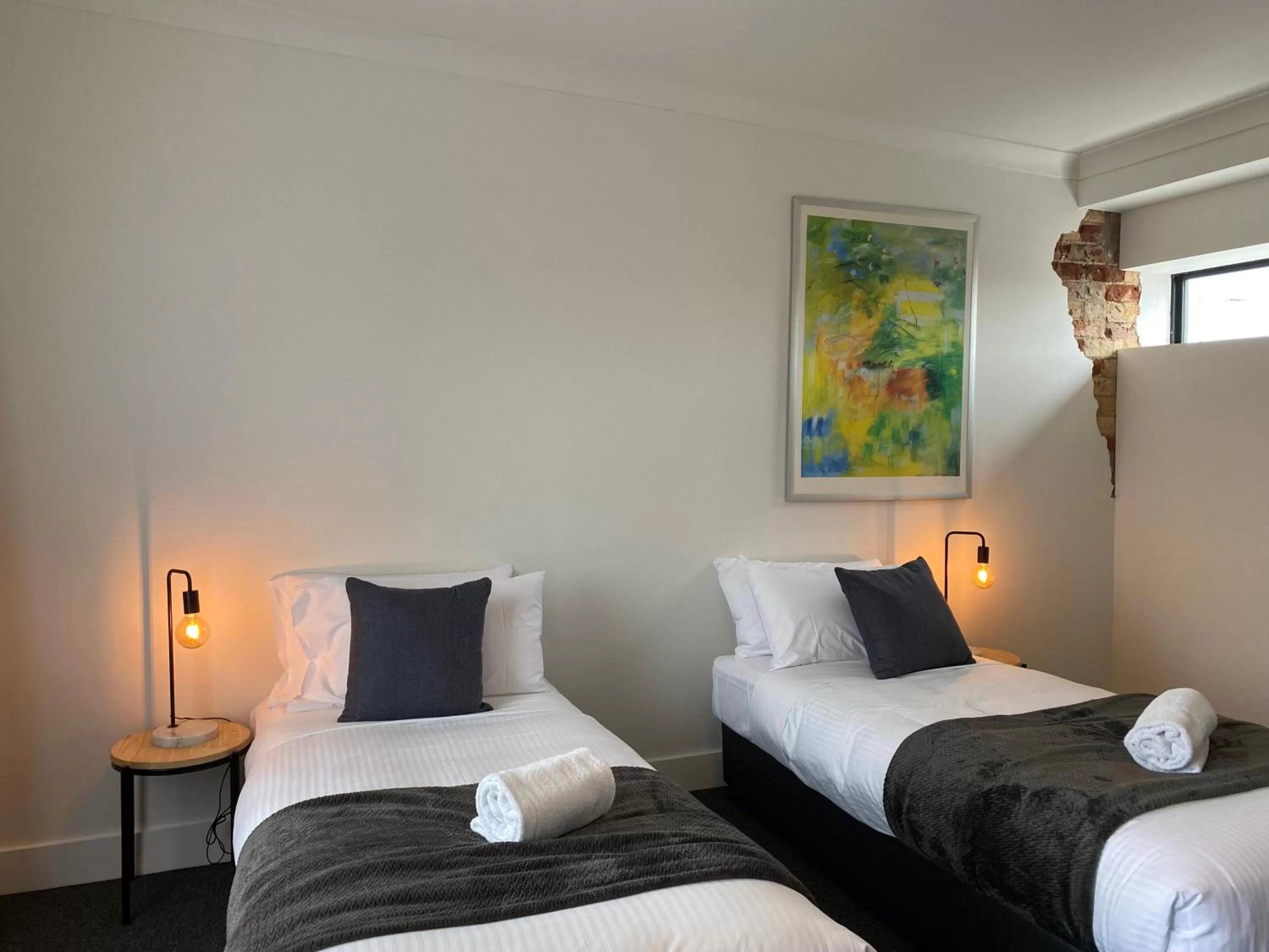 Bed in The Astor Hotel Motel