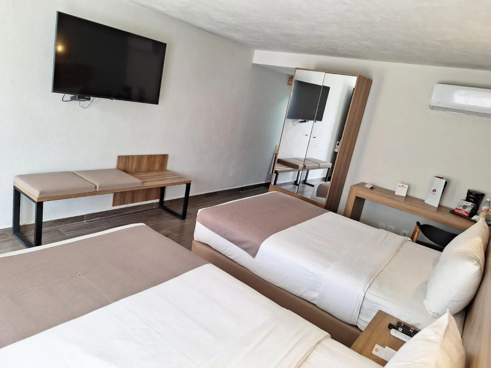 Bed in La Posada Hotel y Suites