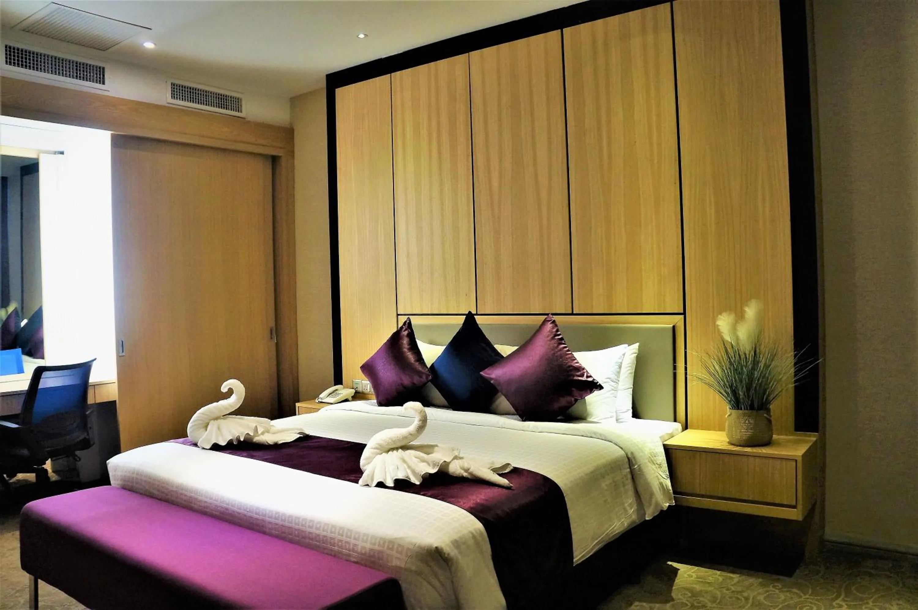 Bed in Greens Hotel & Suites