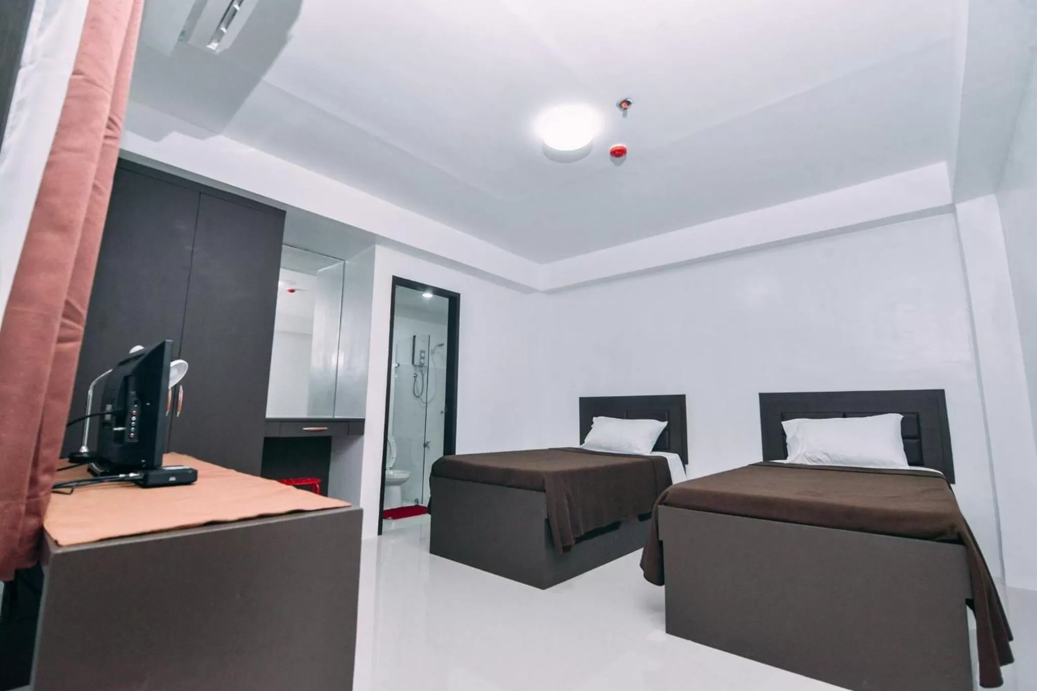 Photo of the whole room, Bed in The Strand Suites and Dormitel