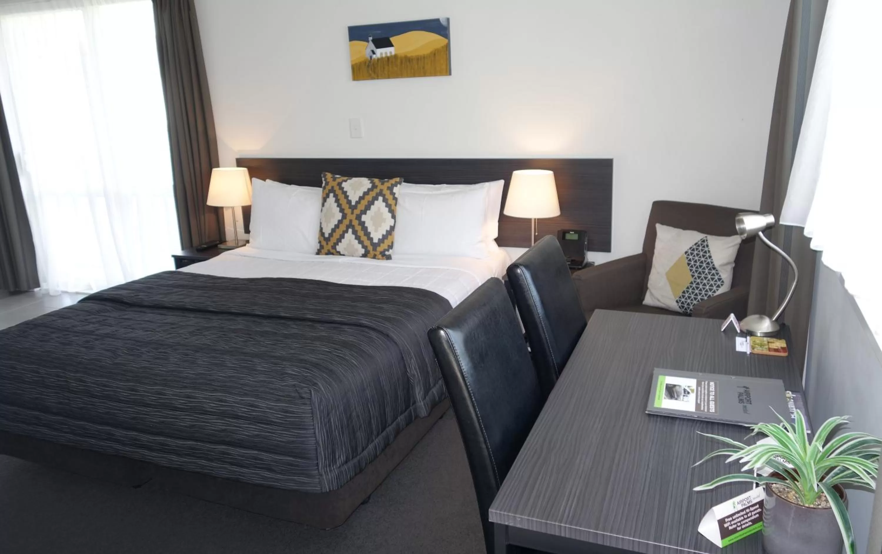 Bed in Airport Palms Motel