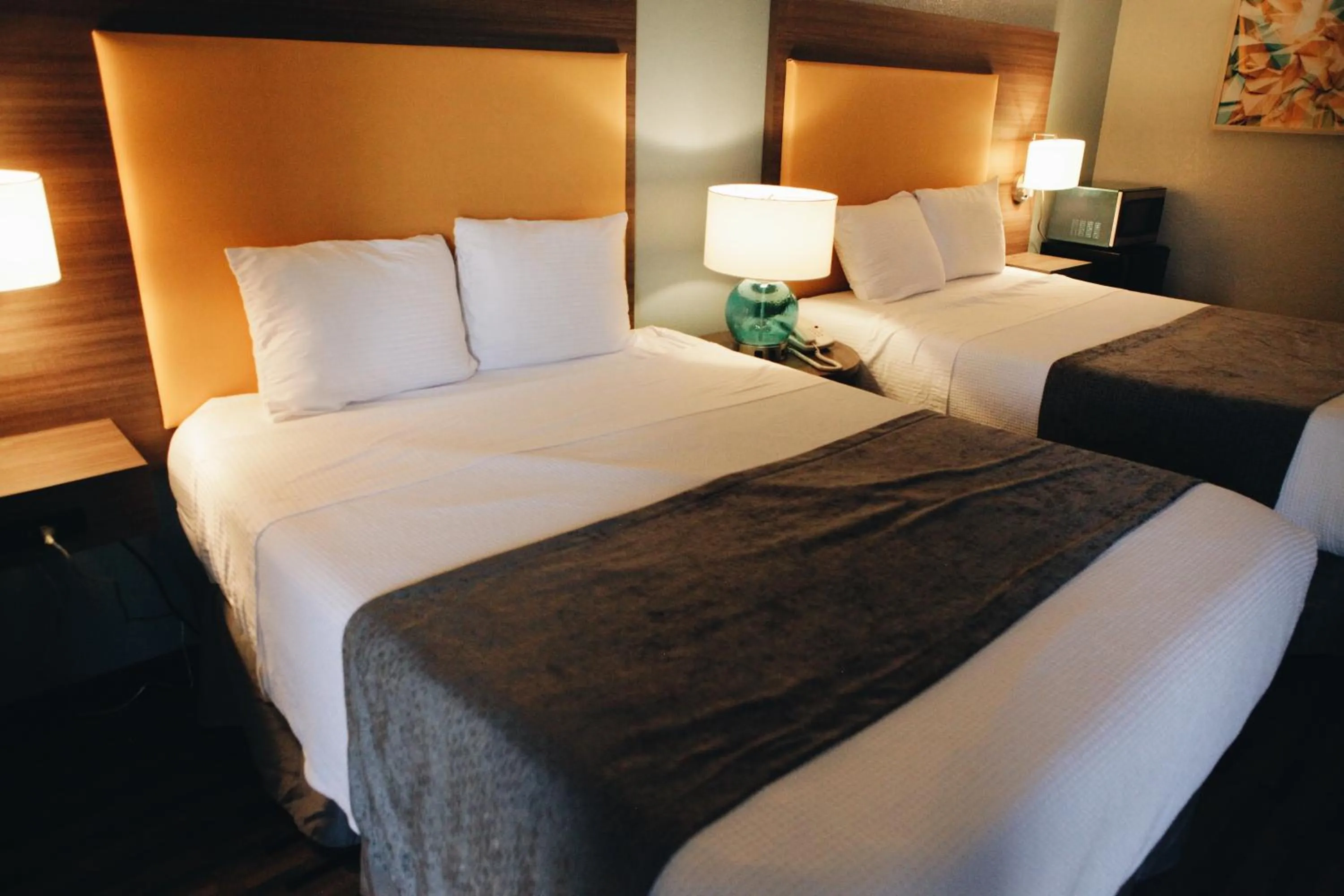 Bed in All Seasons Inn & Suites