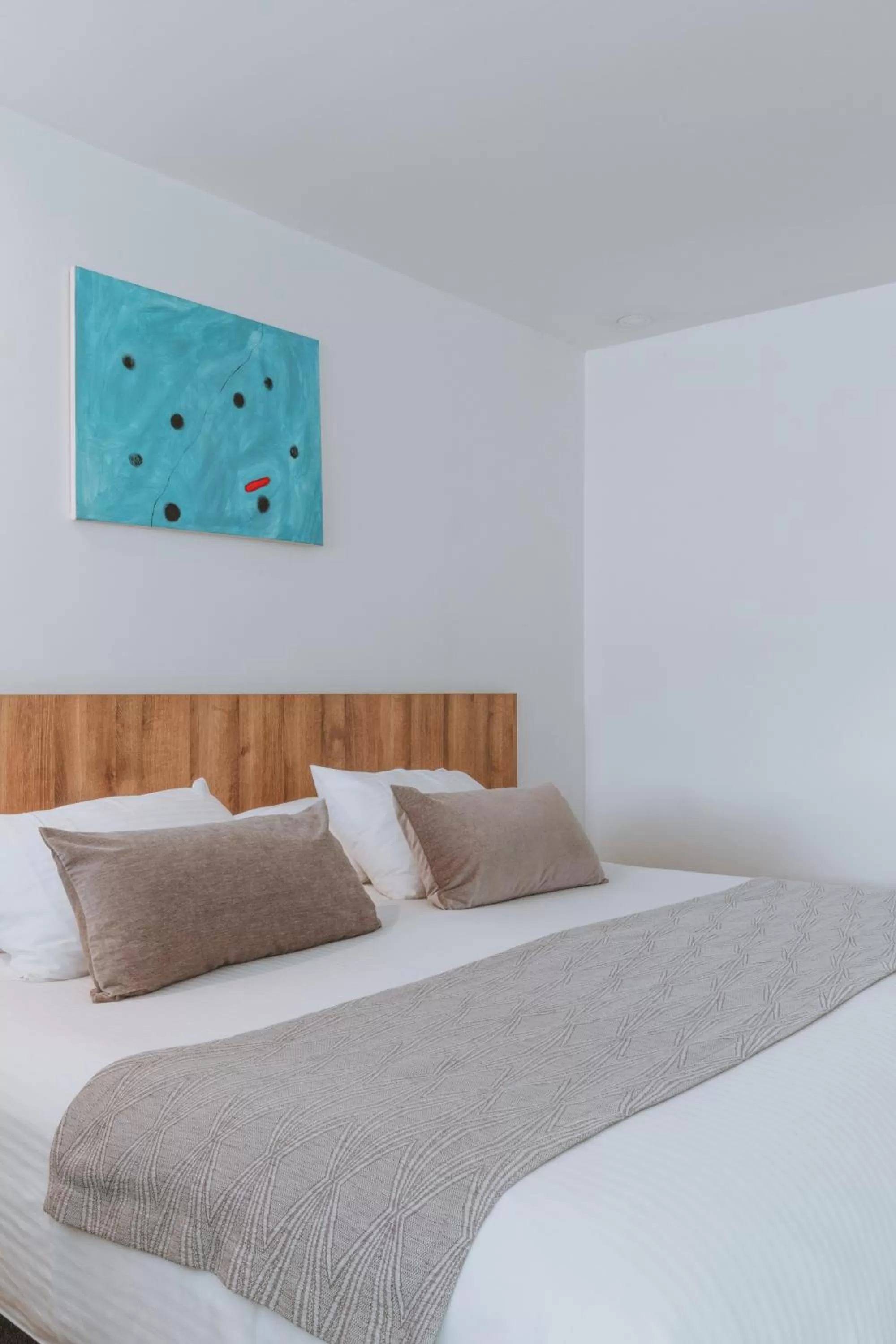 Bed in Travelers Orange Suites