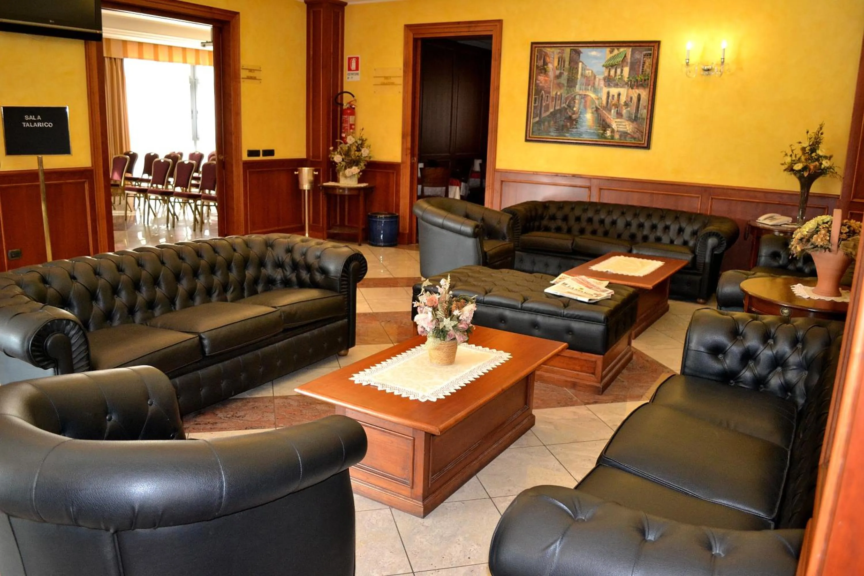 Communal lounge/ TV room in Tricolore Hotel