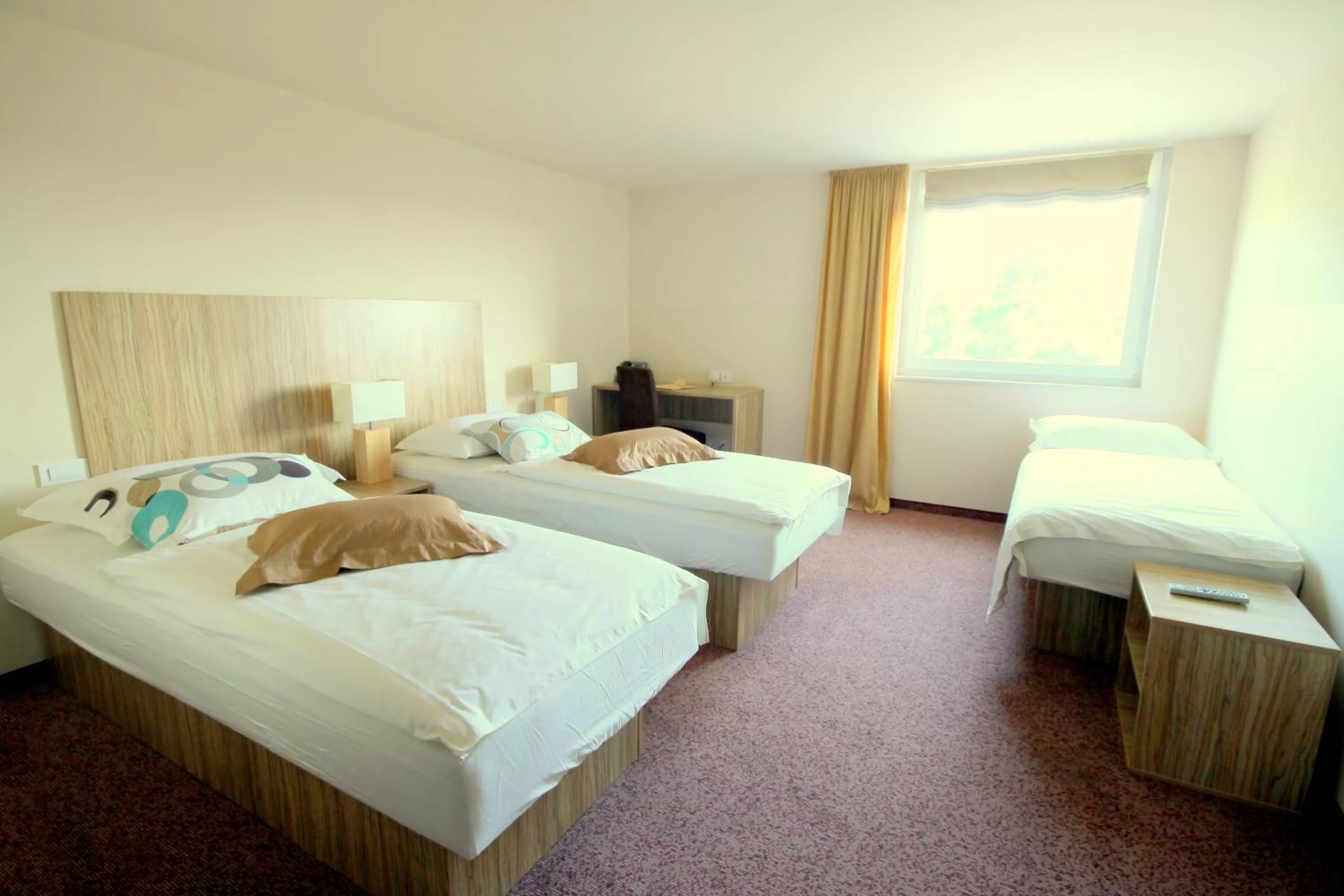 Bed in Ambient Hotel