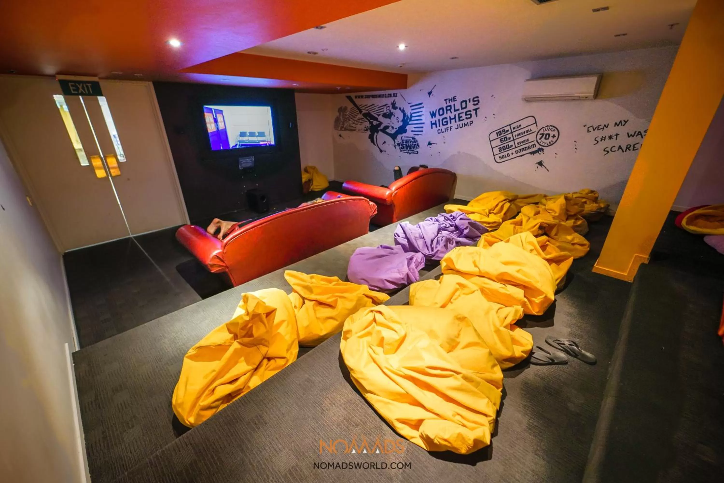 Communal lounge/ TV room in Nomads Queenstown Hostel