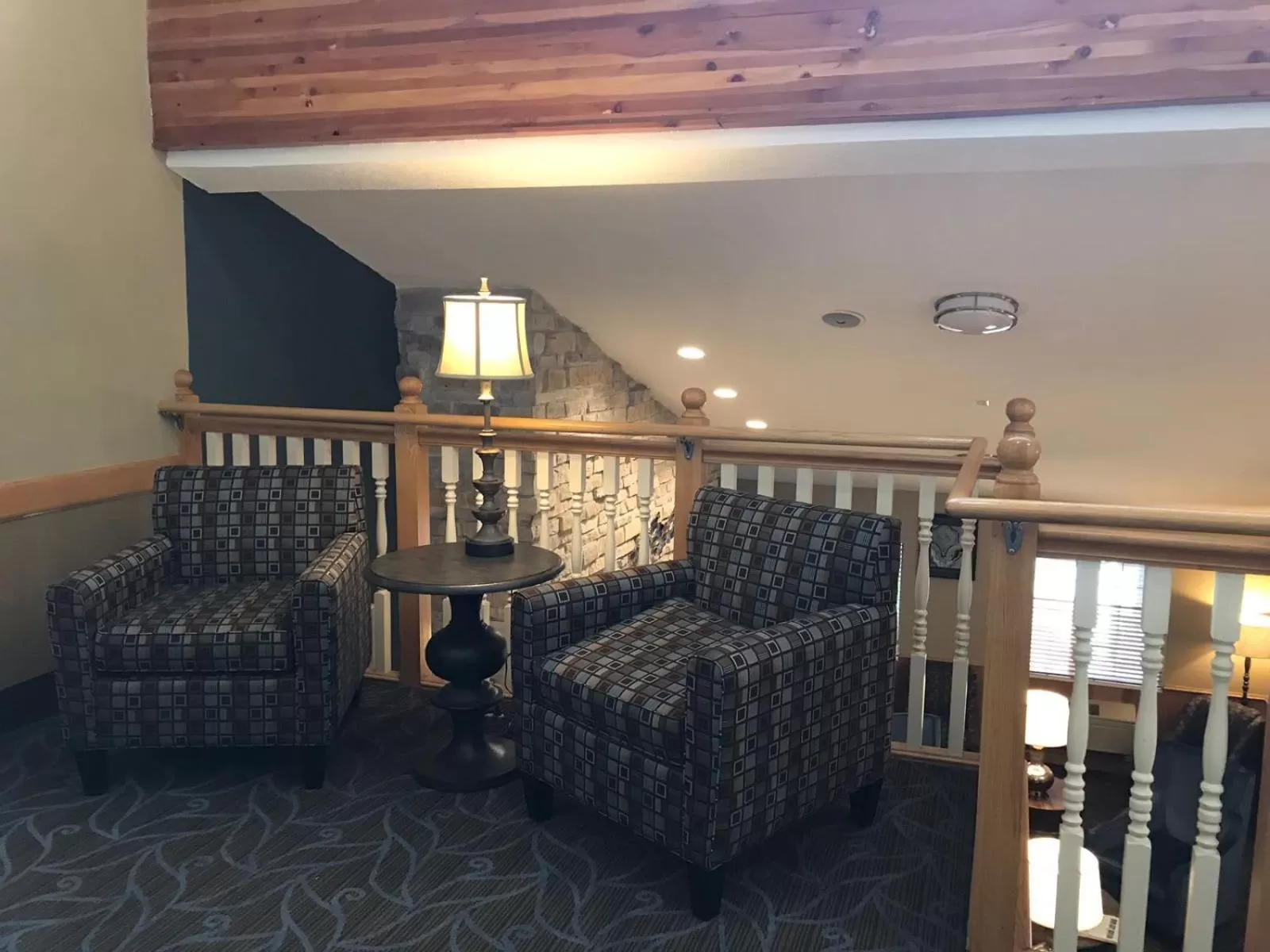 Seating area in AmericInn by Wyndham Hotel and Suites Long Lake