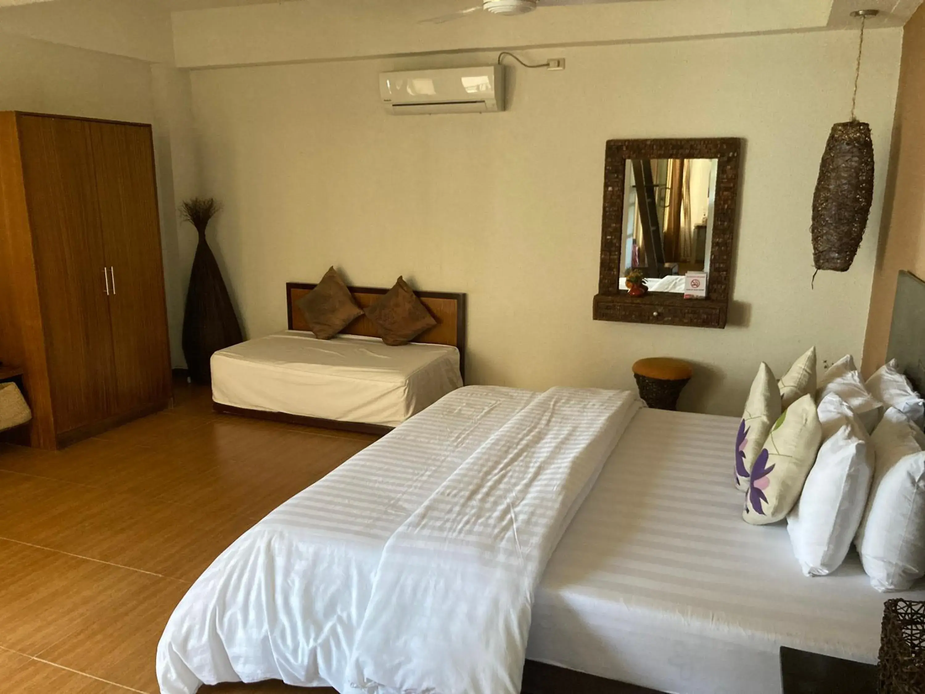 Deluxe Triple Room in Sunset At Aninuan Beach Resort Deluxe Triple Room in Sunset At Aninuan Beach Resort