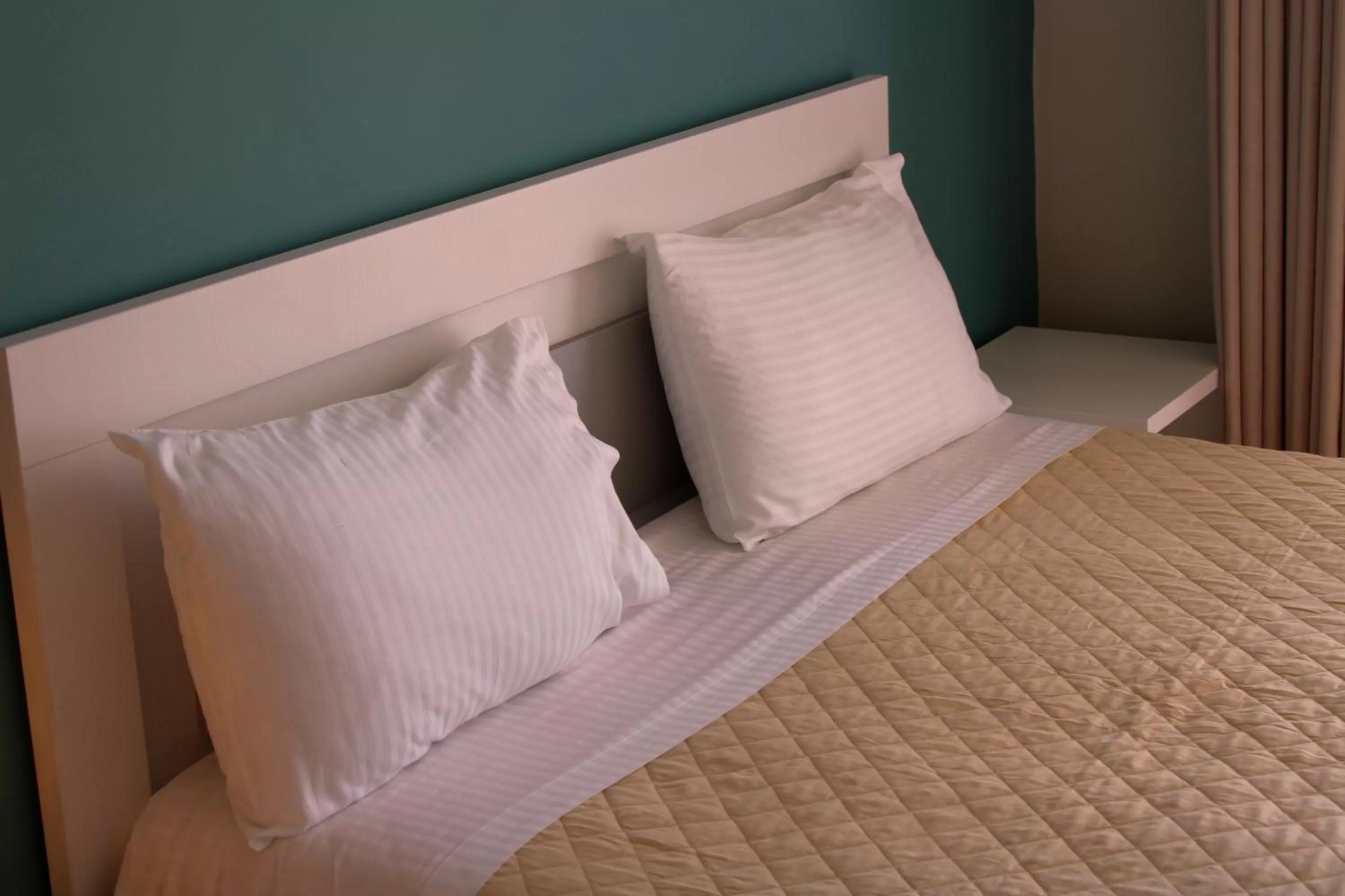 Bed in Aphrodite Garden Rooms & Apartment