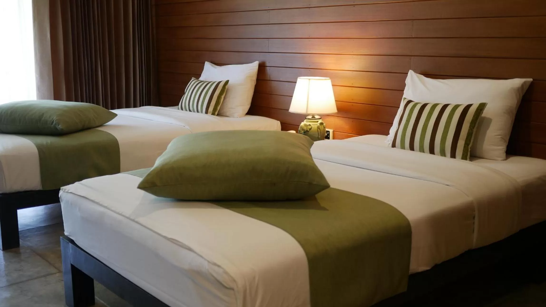 Bed in Royal River Kwai Resort and Spa