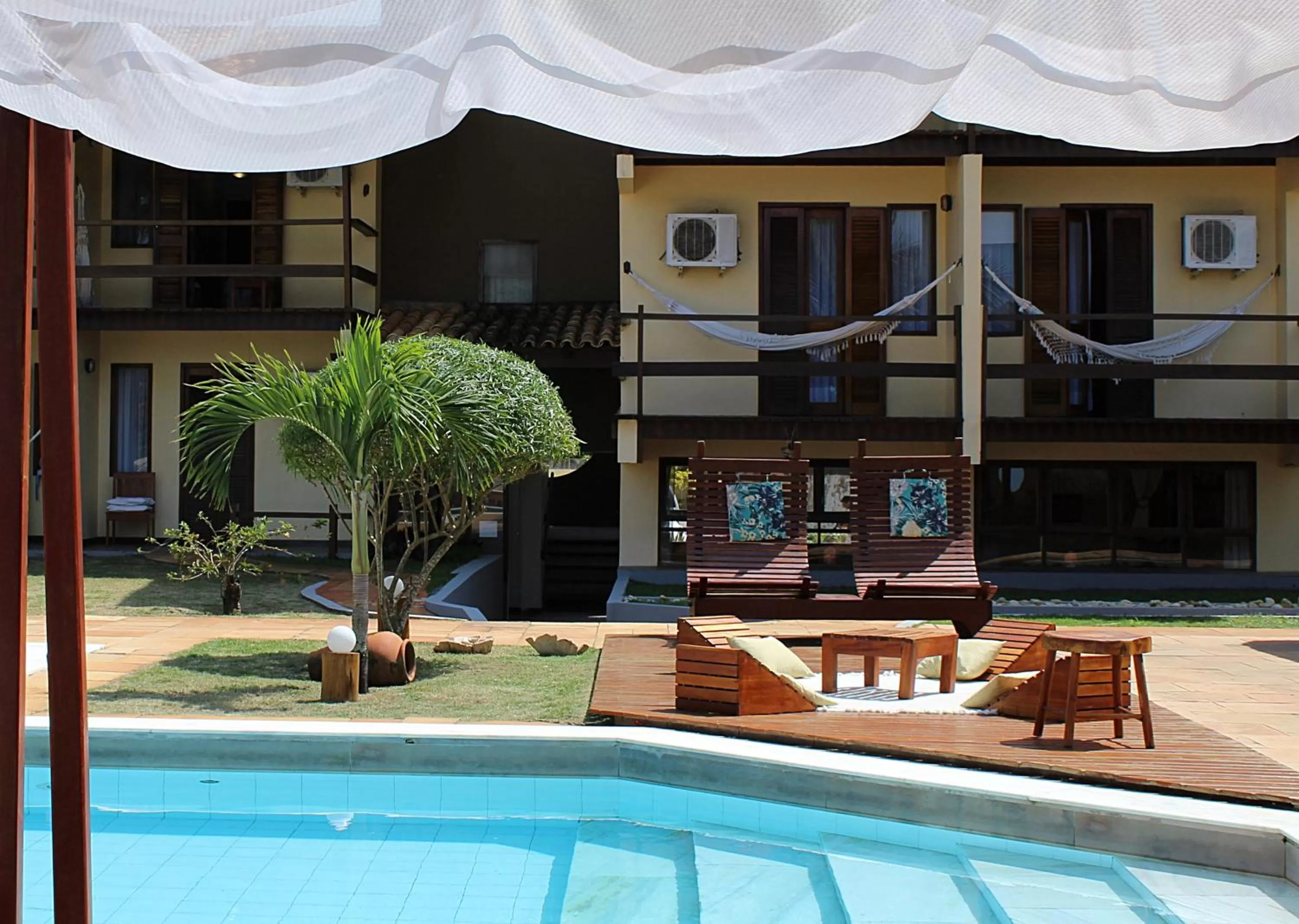 Balcony/Terrace, Swimming Pool in Pousada dos Hibiscus