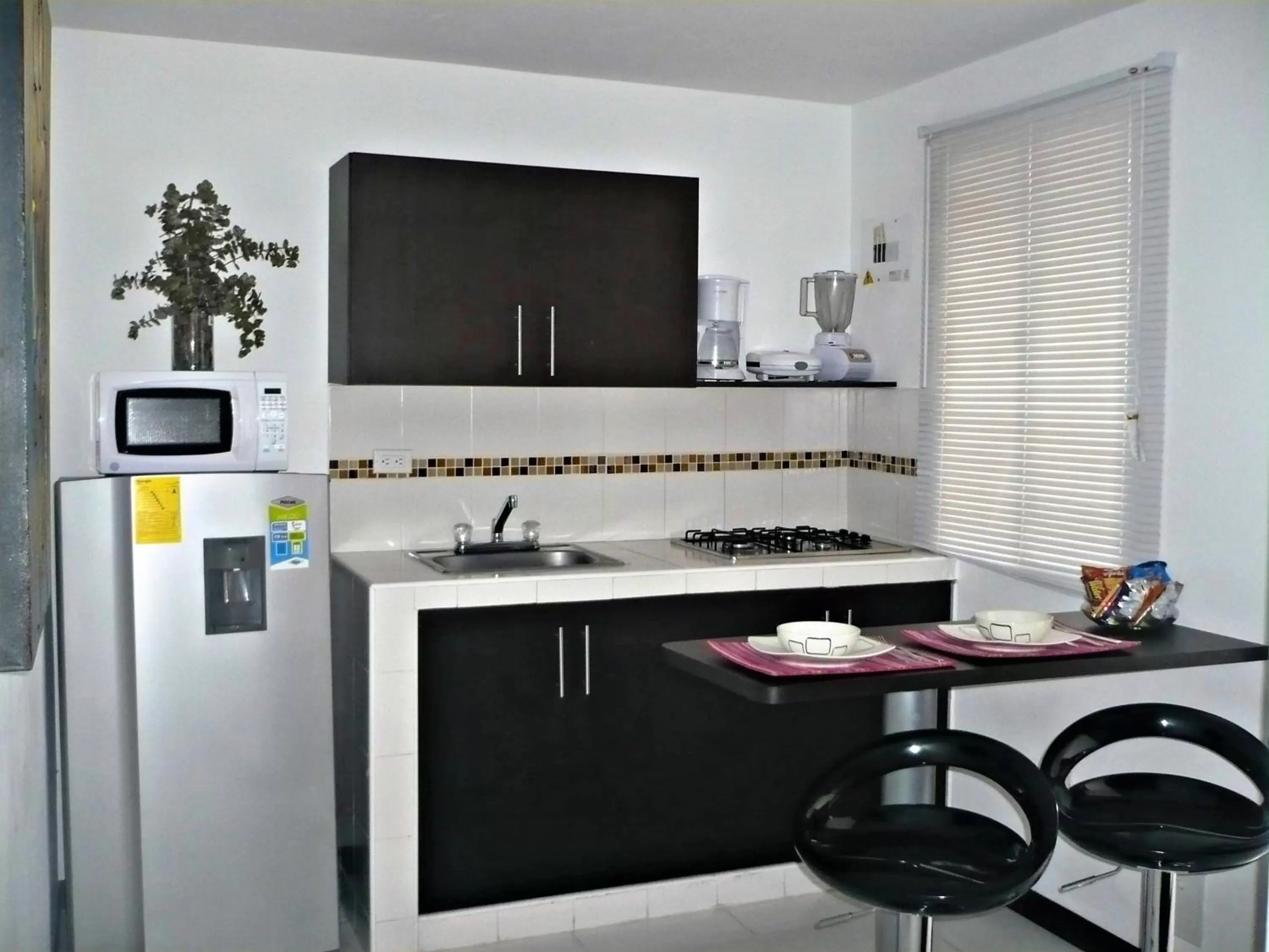 Kitchen or kitchenette in Apartasuites San Marcos