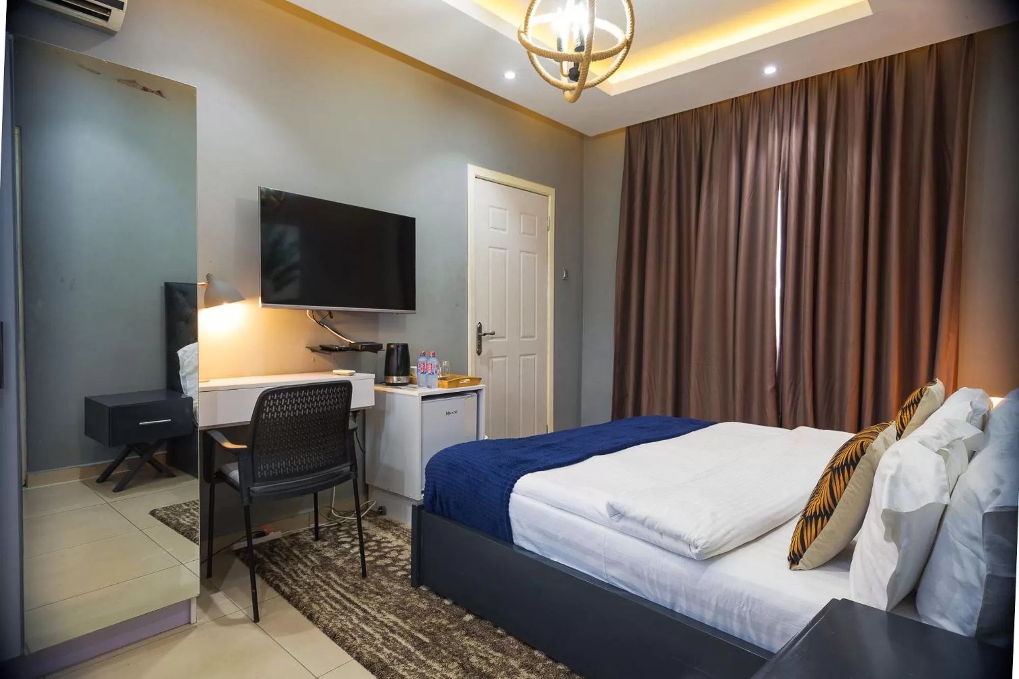 Bed, TV/Entertainment Center in The Avery Suites, East Legon