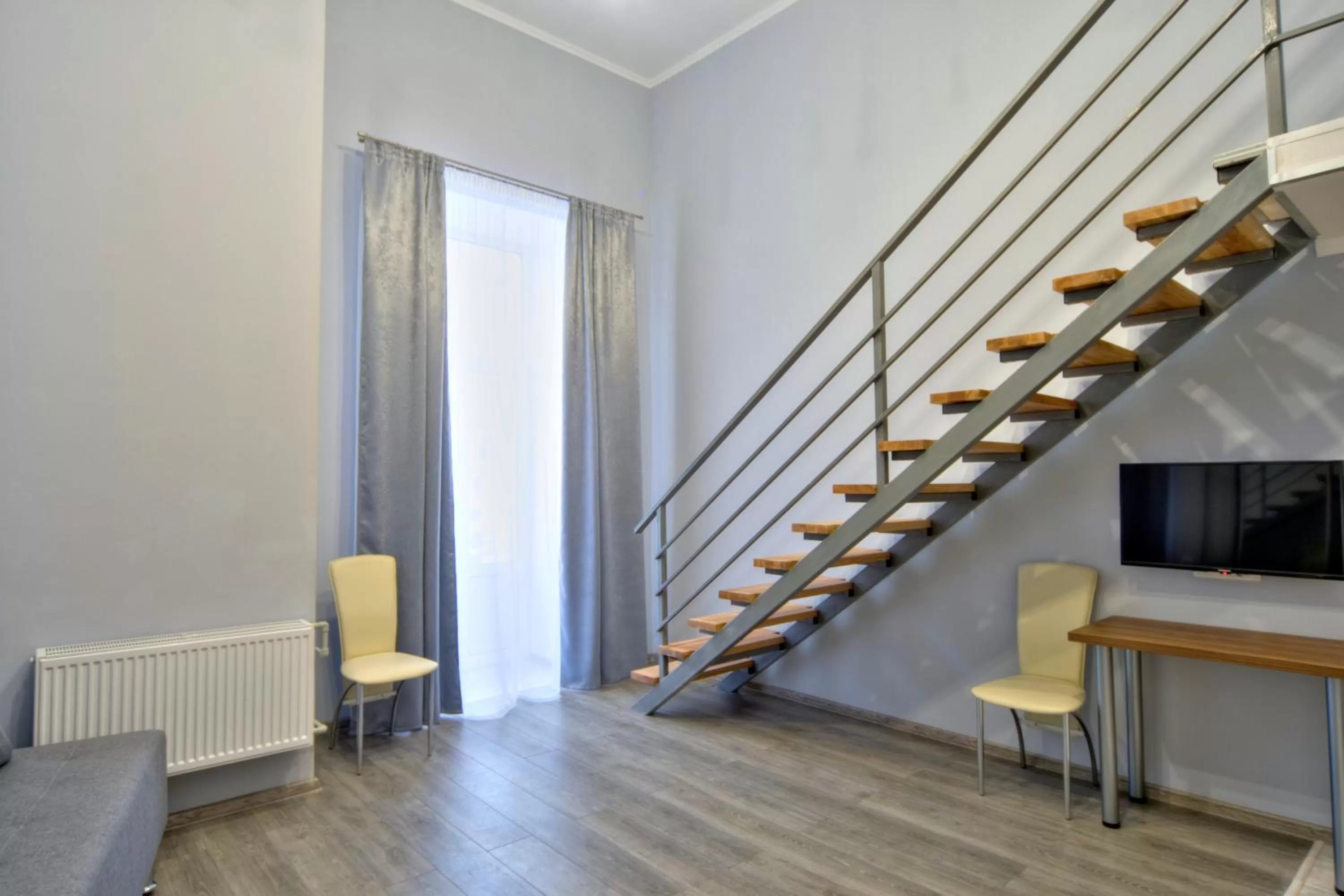 Living room, TV/Entertainment Center in Grand Apartments