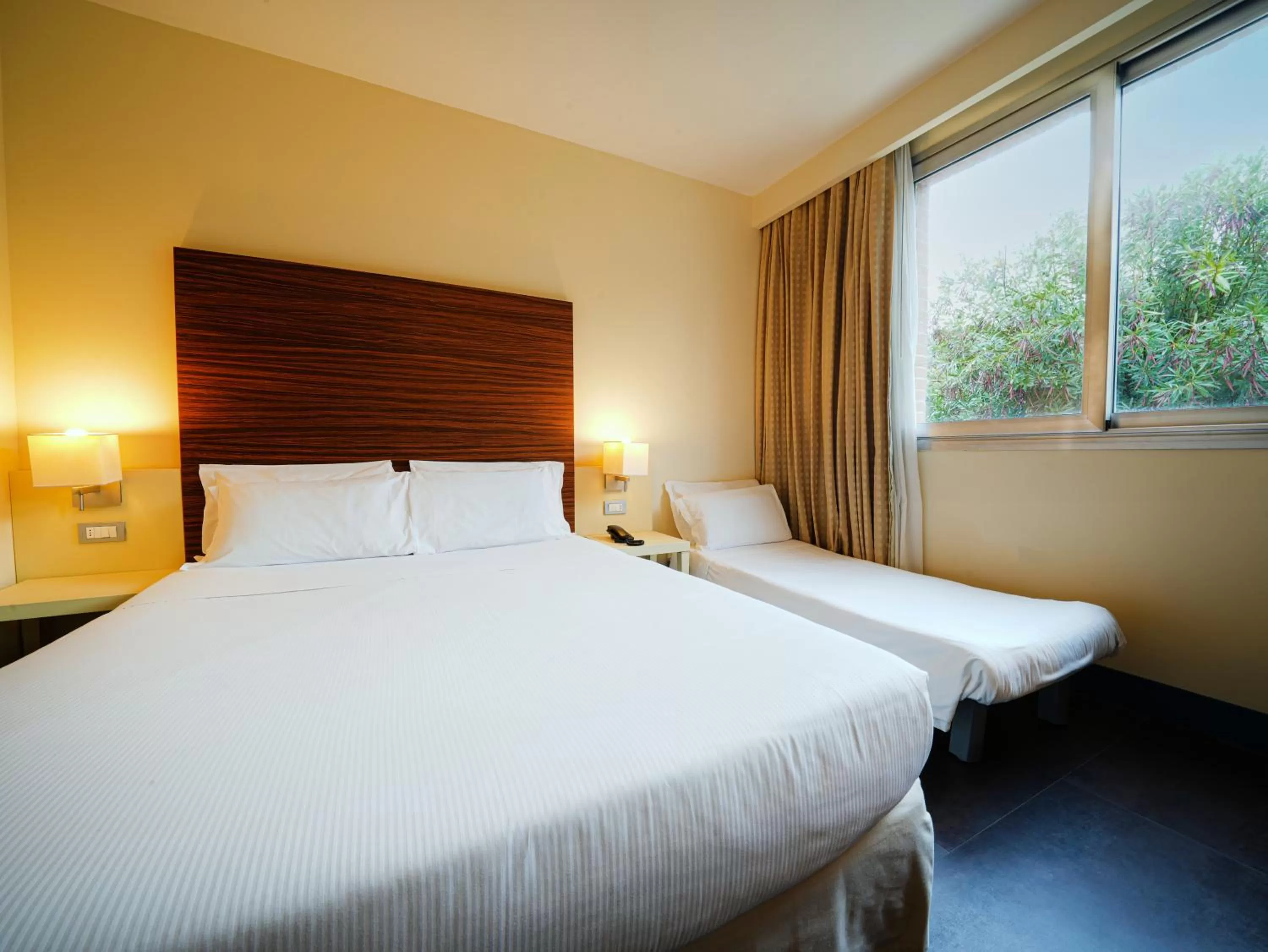 Bed in La Meridiana Bleisure Hotel