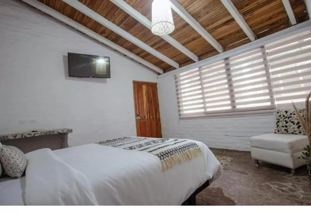 Bed in Rústic Hotel Quinta La Aurora