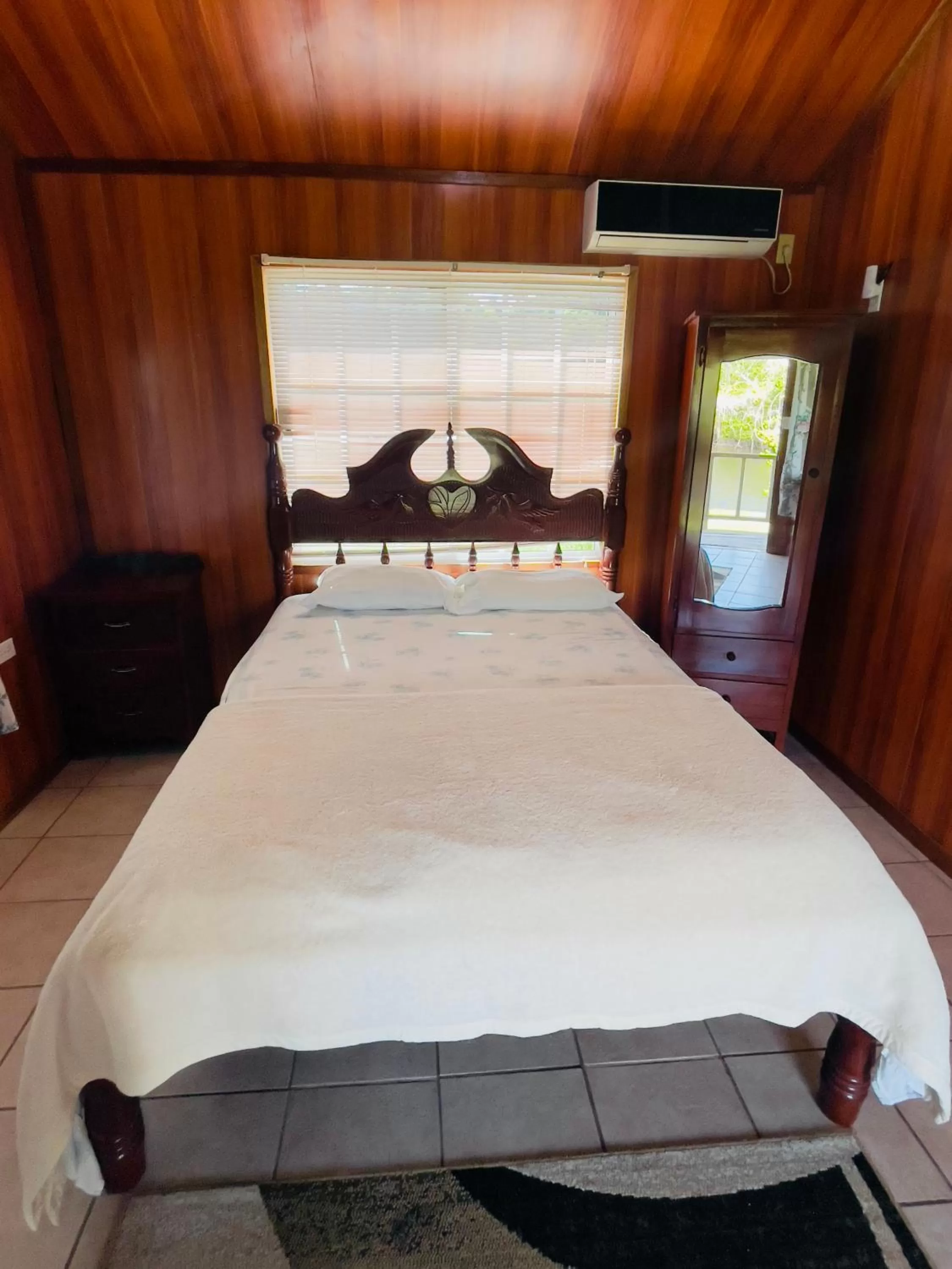 Bed in Lamanai Riverside Retreat