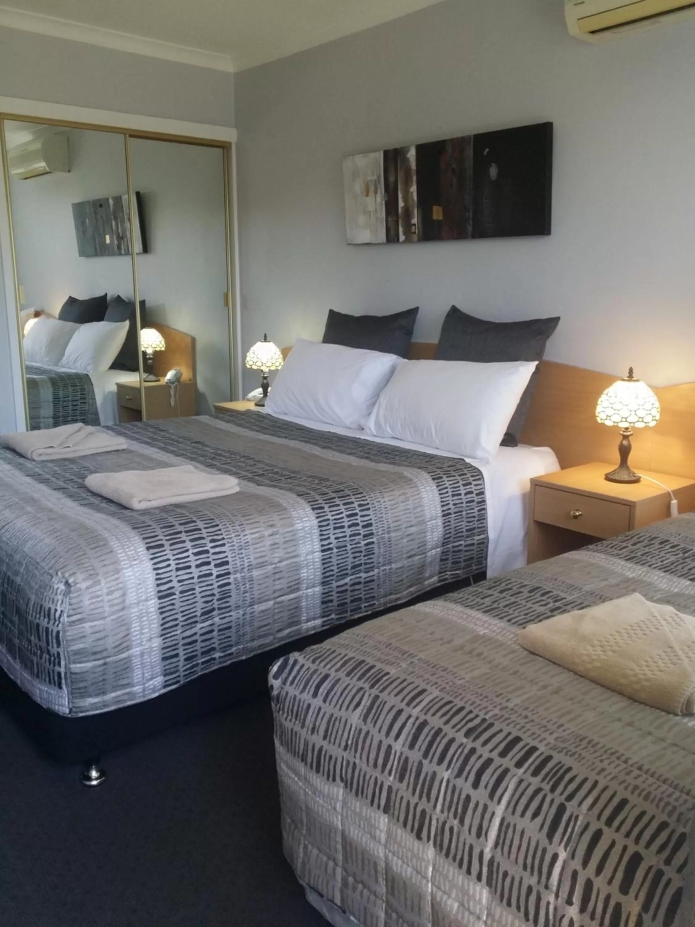 Bed in White Manor Motel