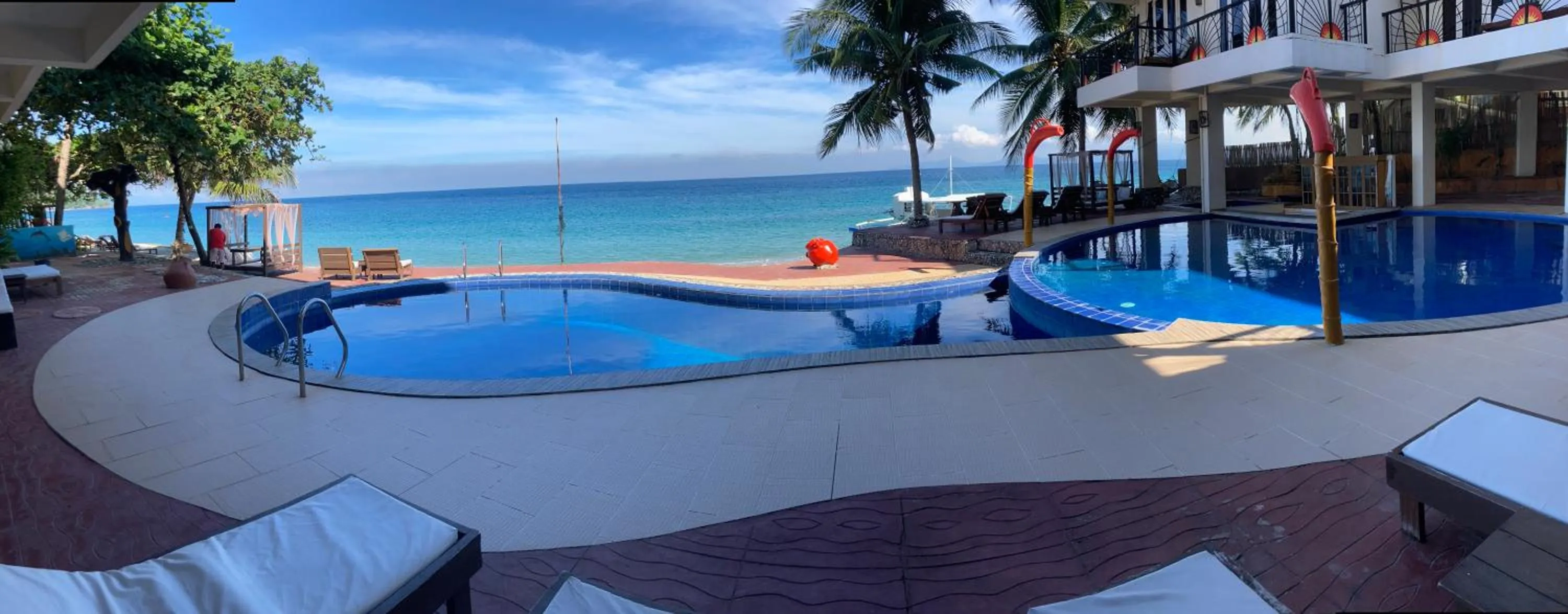Swimming Pool in Sunset At Aninuan Beach Resort