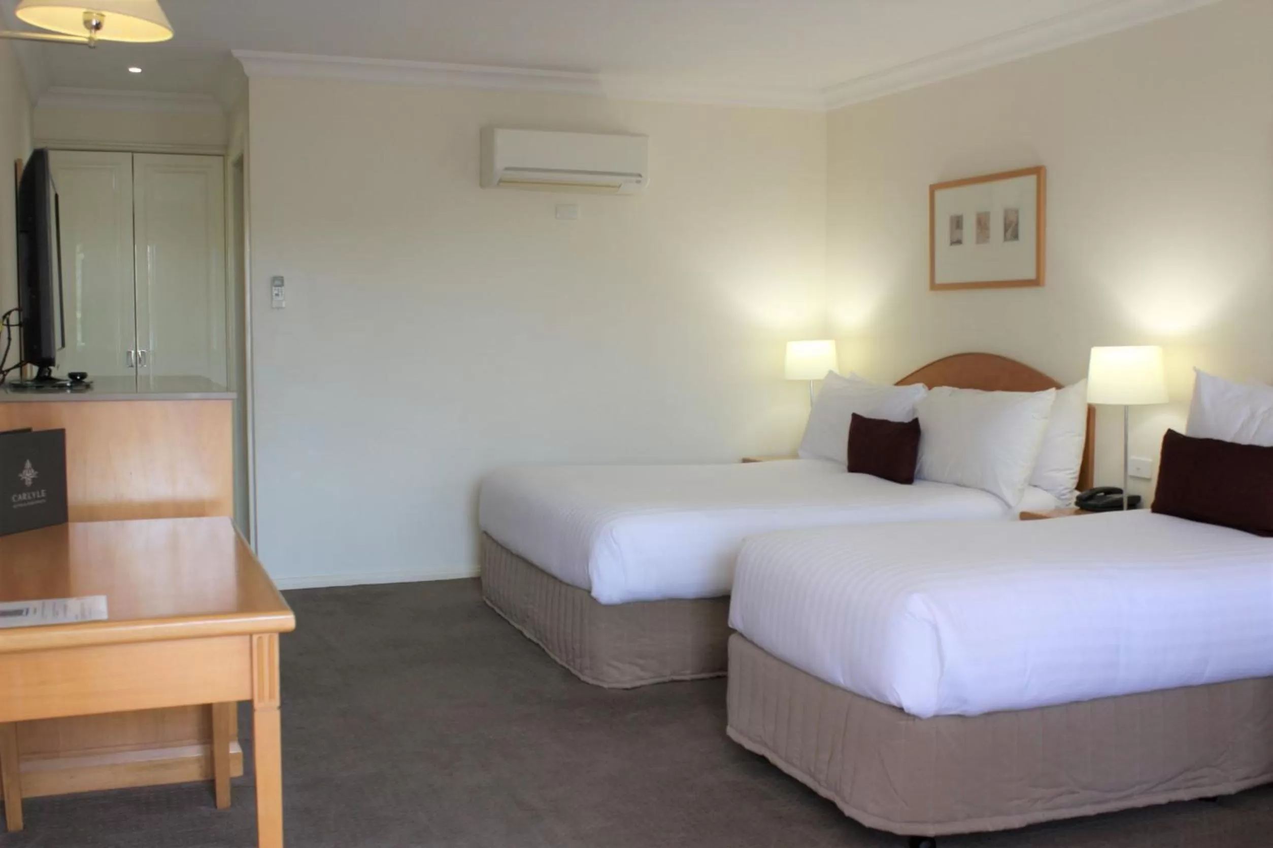 Bed in Carlyle Suites & Apartments