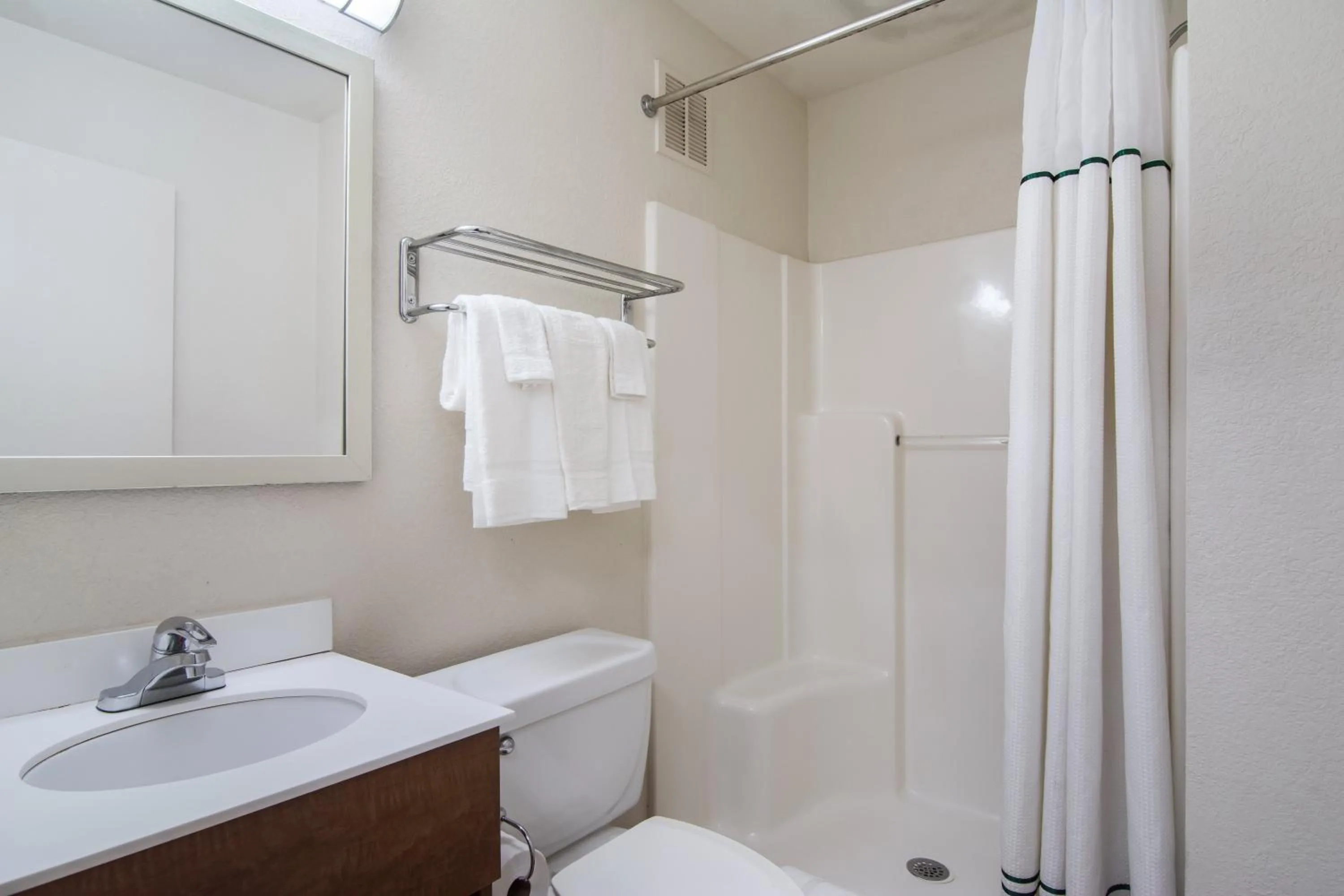 Bathroom in HomeTowne Studios by Red Roof Raleigh – Durham