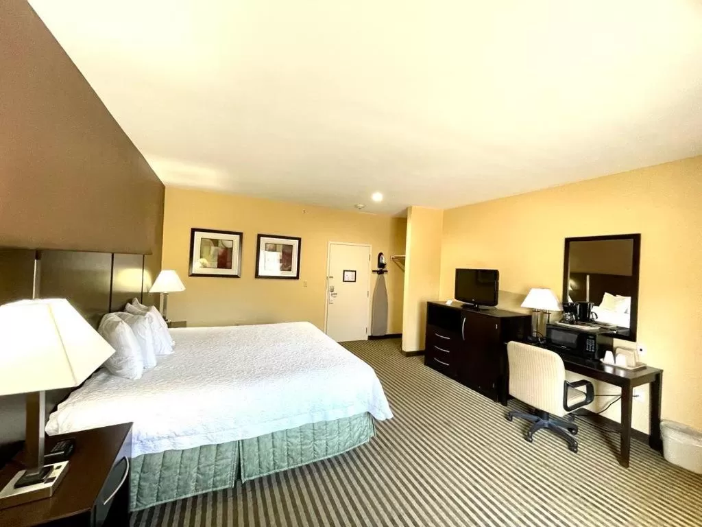 Bed in Whitney Inn & Suites