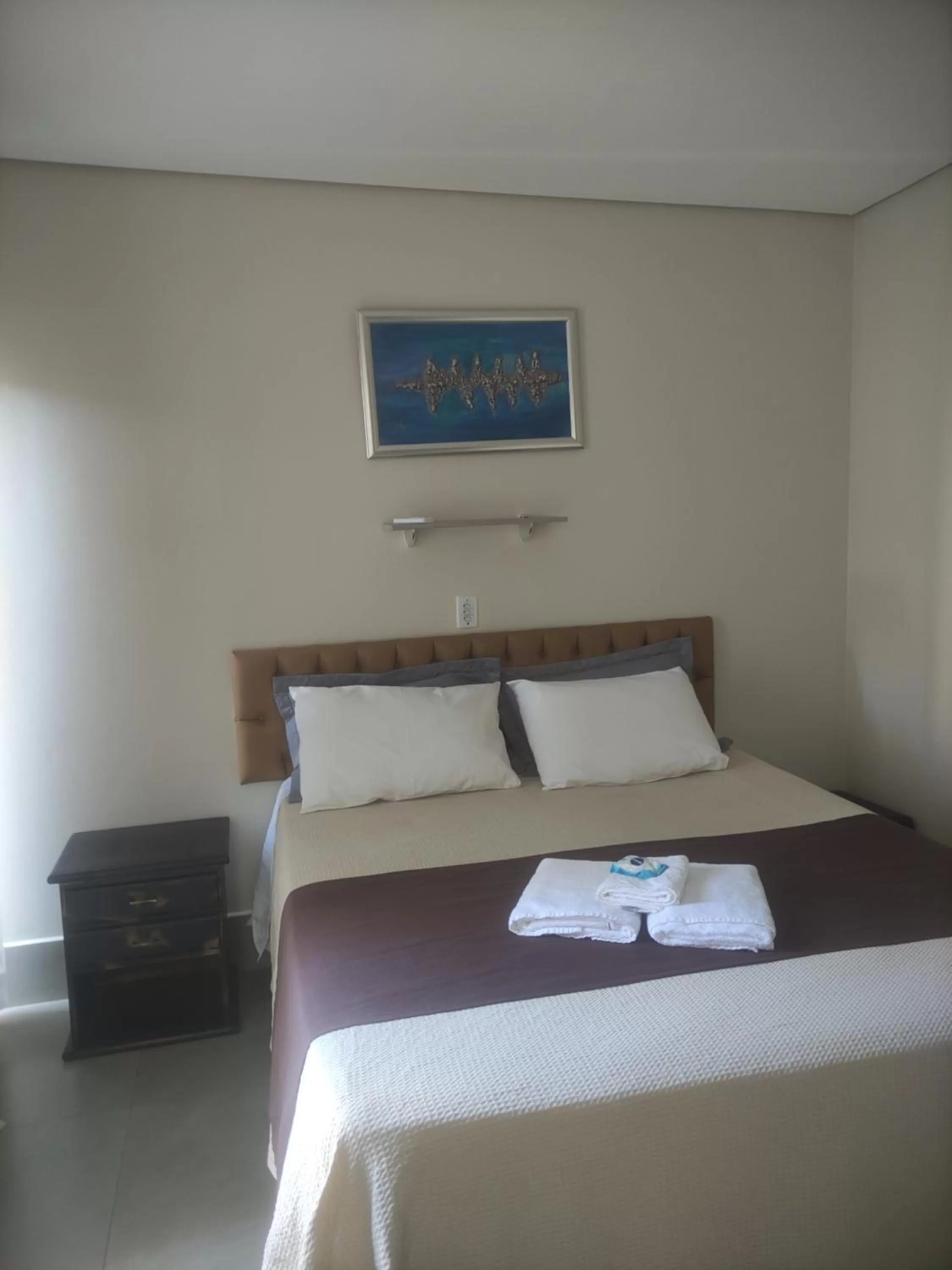 Bed in Pousada da Gi Suítes e Turismo