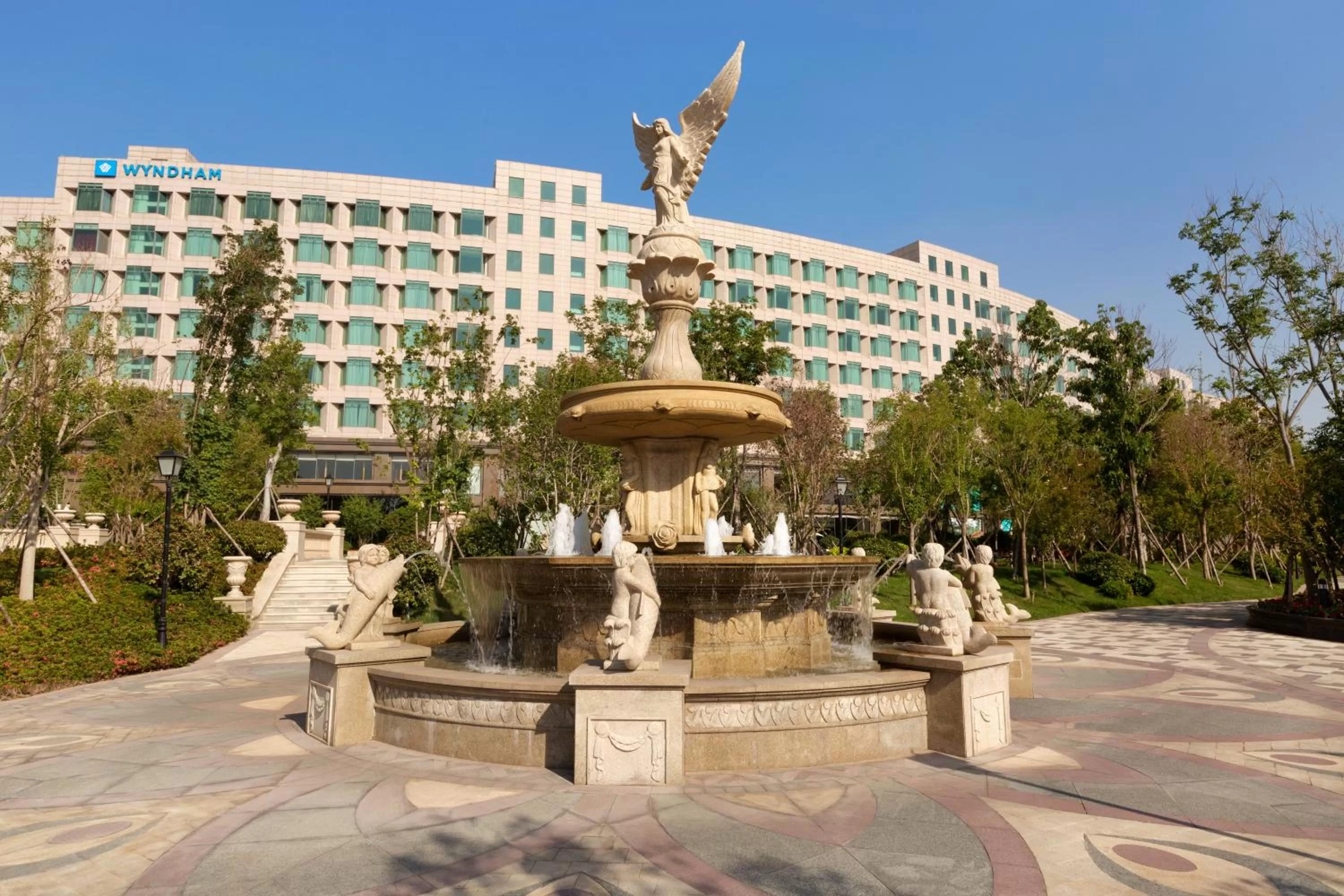 Facade/entrance in Wyndham Qingdao l Free Fixed-Time Shuttle Service Between Hotel and Airport & North Railway Station l Outdoor Children's Amusement Park l 1-Hour Play Snooker or Table Tennis
