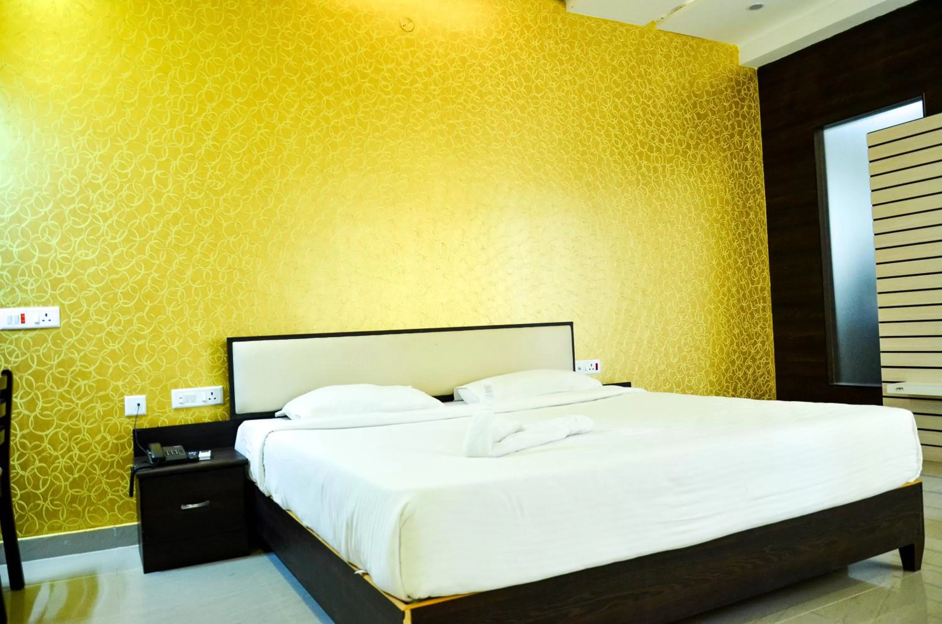 Bed in Hotel Ambai Grand