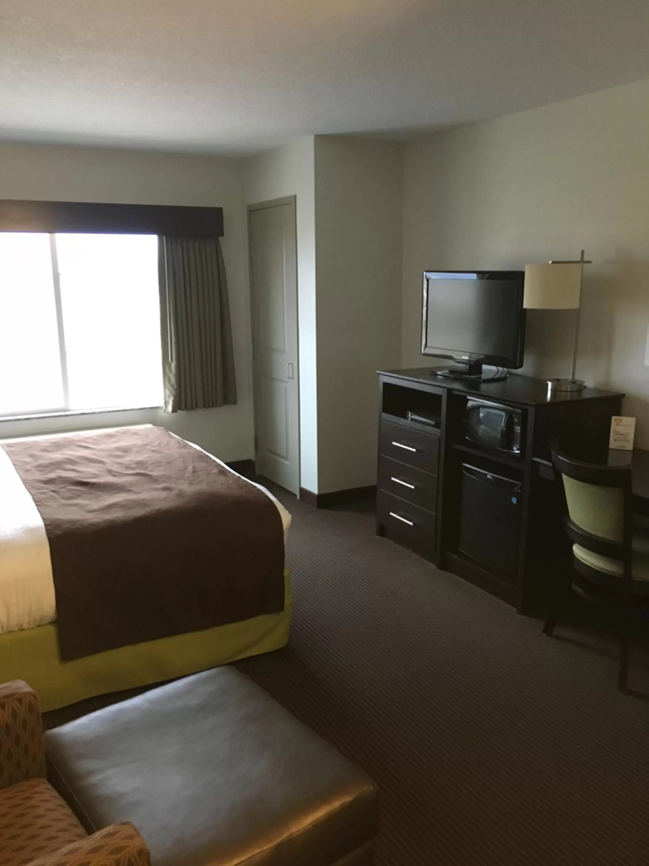 Bed in AmericInn by Wyndham Fairfield