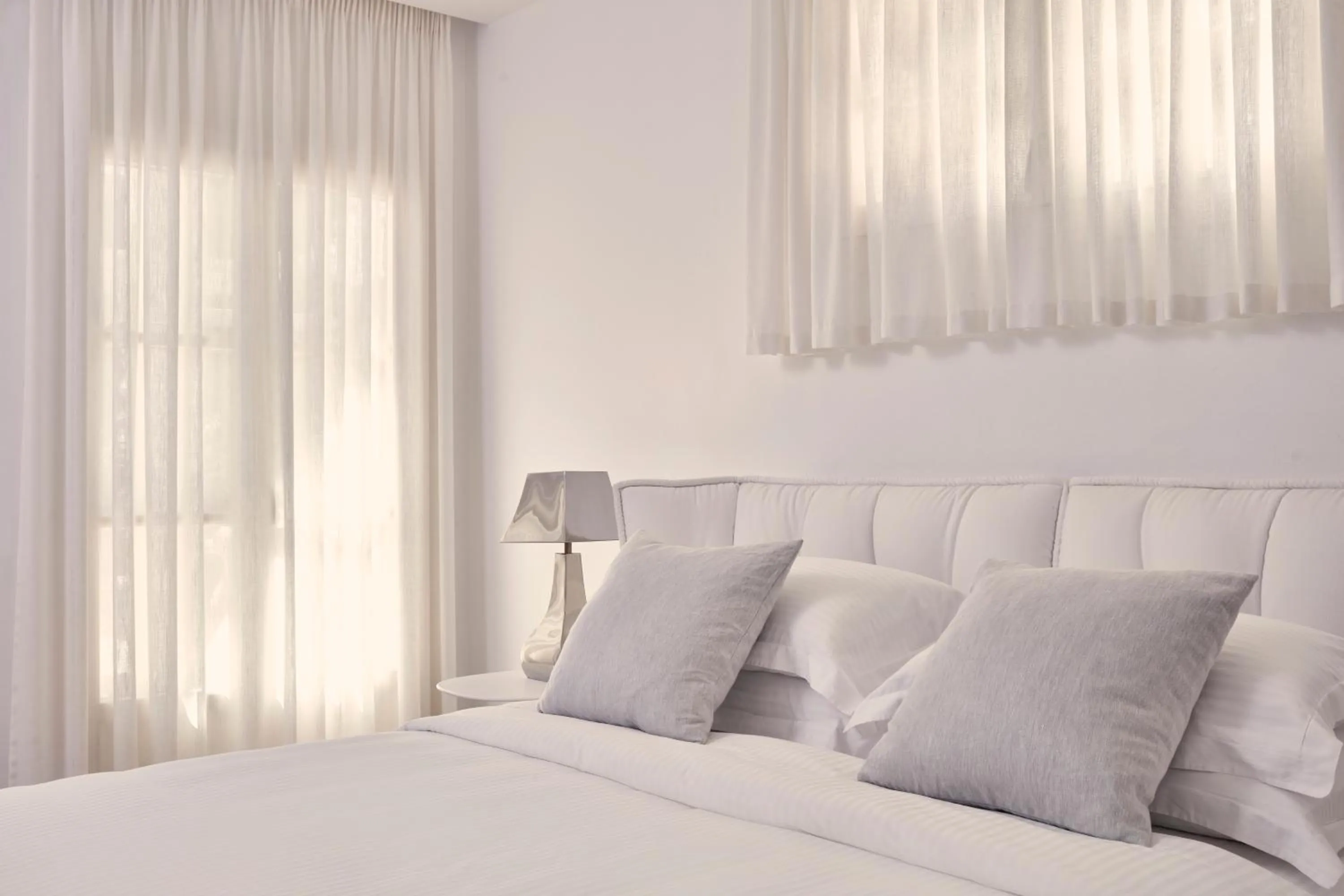 Bed in Myconian Ambassador Relais & Chateaux