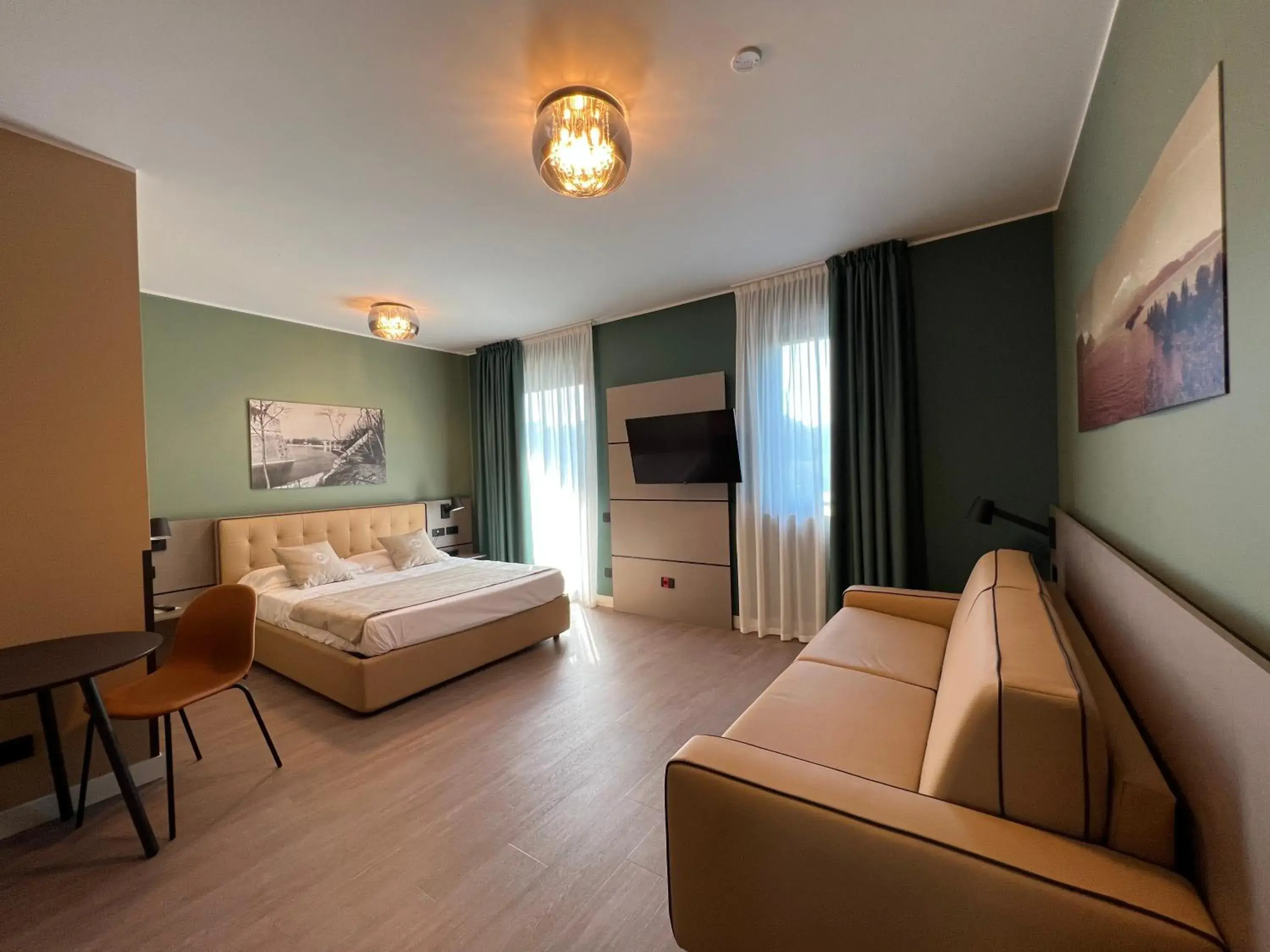 Superior Triple Room With Balcony and Partial Lake View in Hotel Puccini Superior Triple Room With Balcony and Partial Lake View in Hotel Puccini