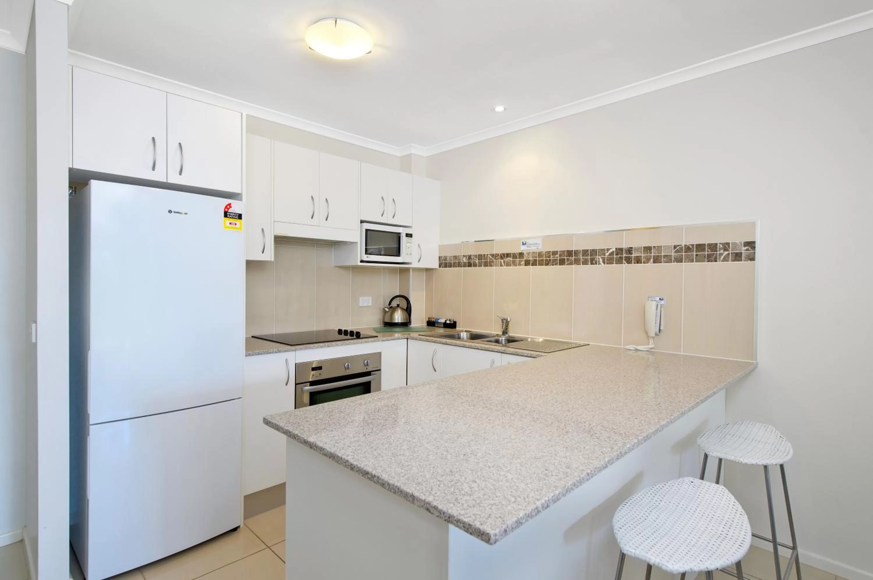 Kitchen or kitchenette in South Pacific Apartments
