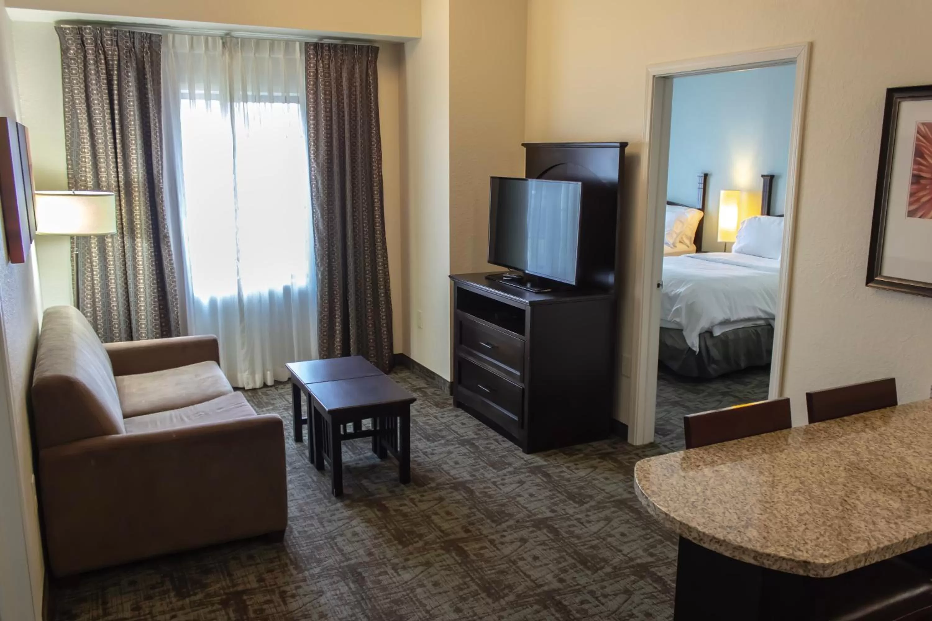Seating area, Bed in Staybridge Suites Minot by IHG