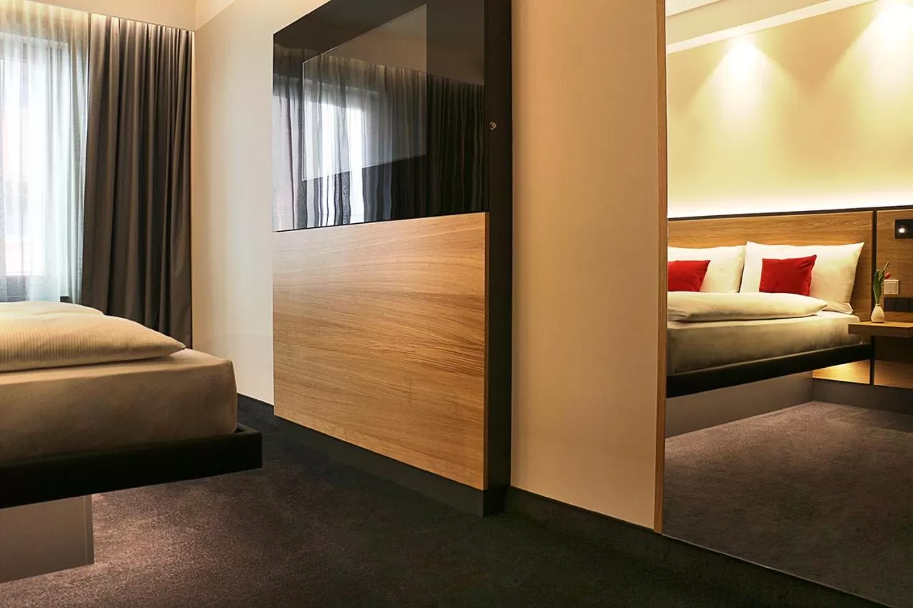 Photo of the whole room, Bed in GINN City and Lounge Ravensburg