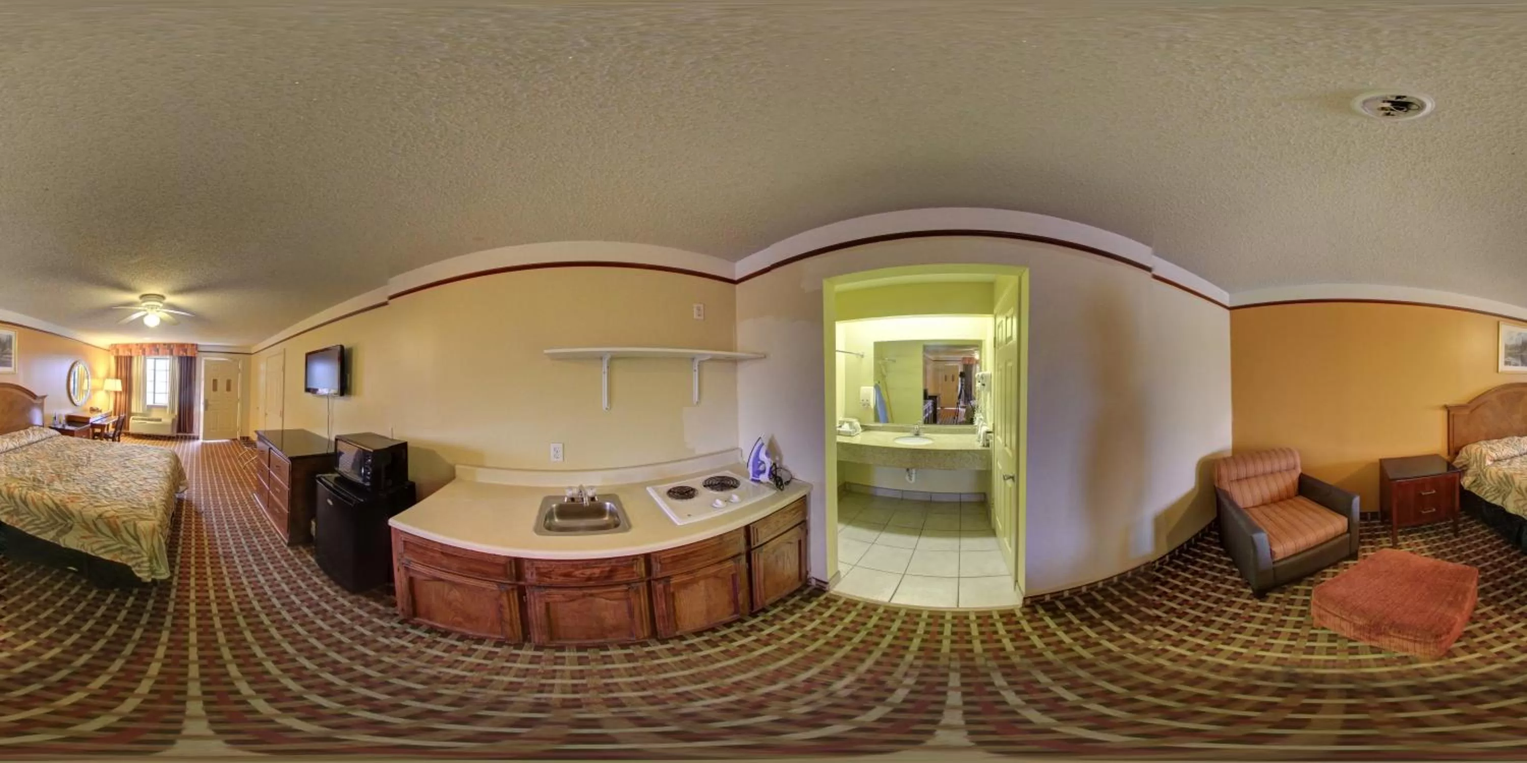 Kitchen or kitchenette, Bed in Deluxe Inn and Suites