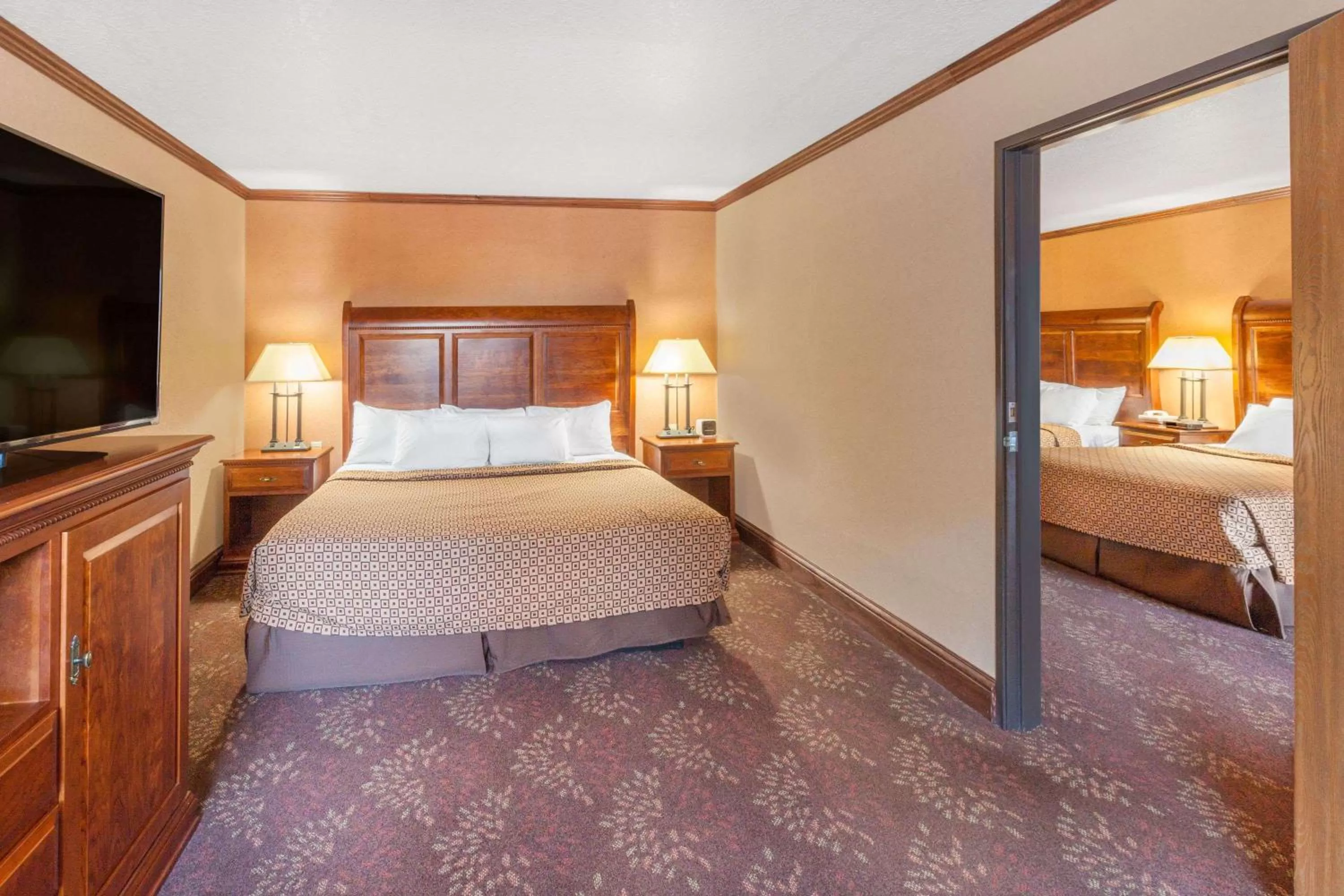 Photo of the whole room, Bed in Ramada by Wyndham Mackinaw City Waterfront